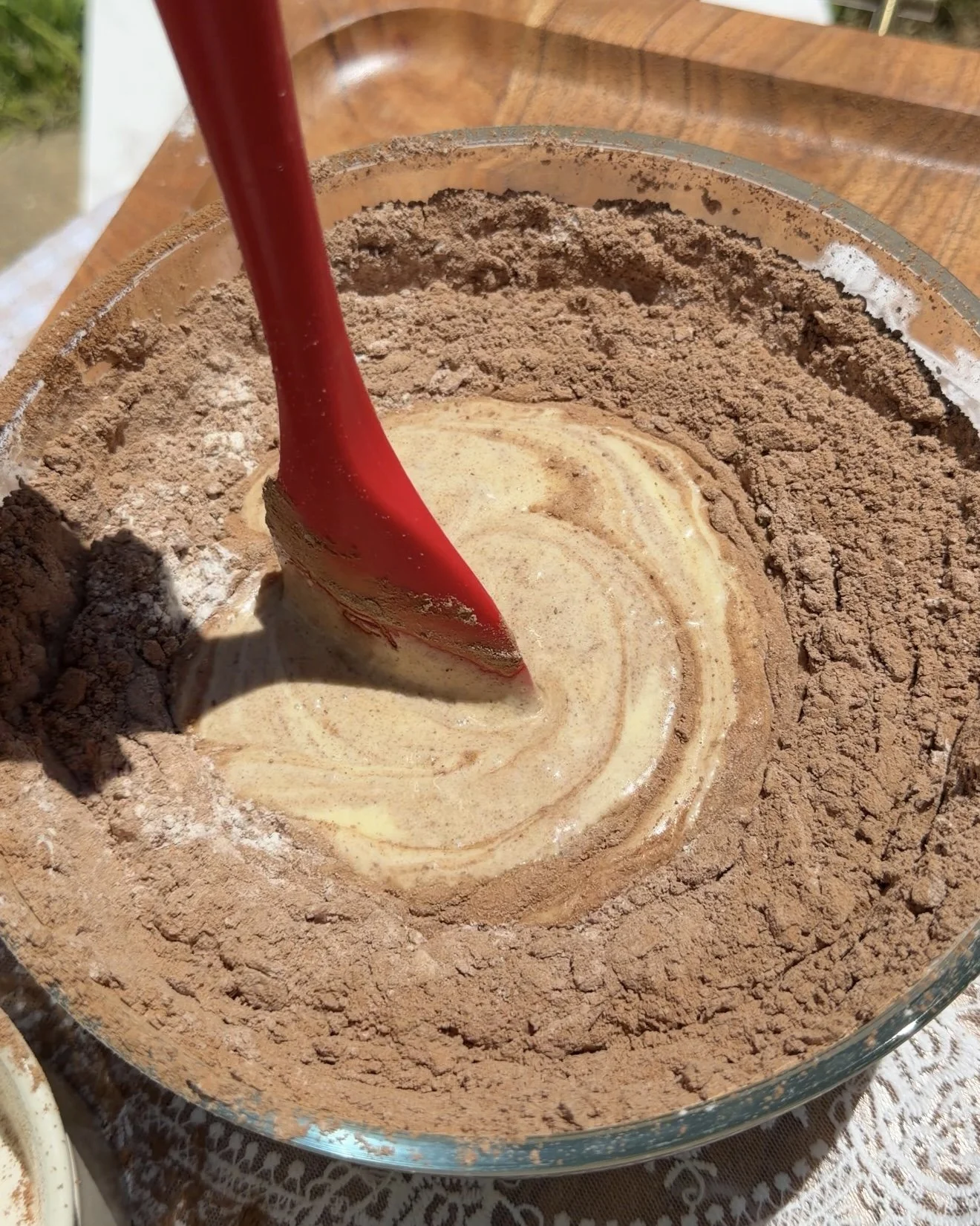 Red spatula mixing brownie batter