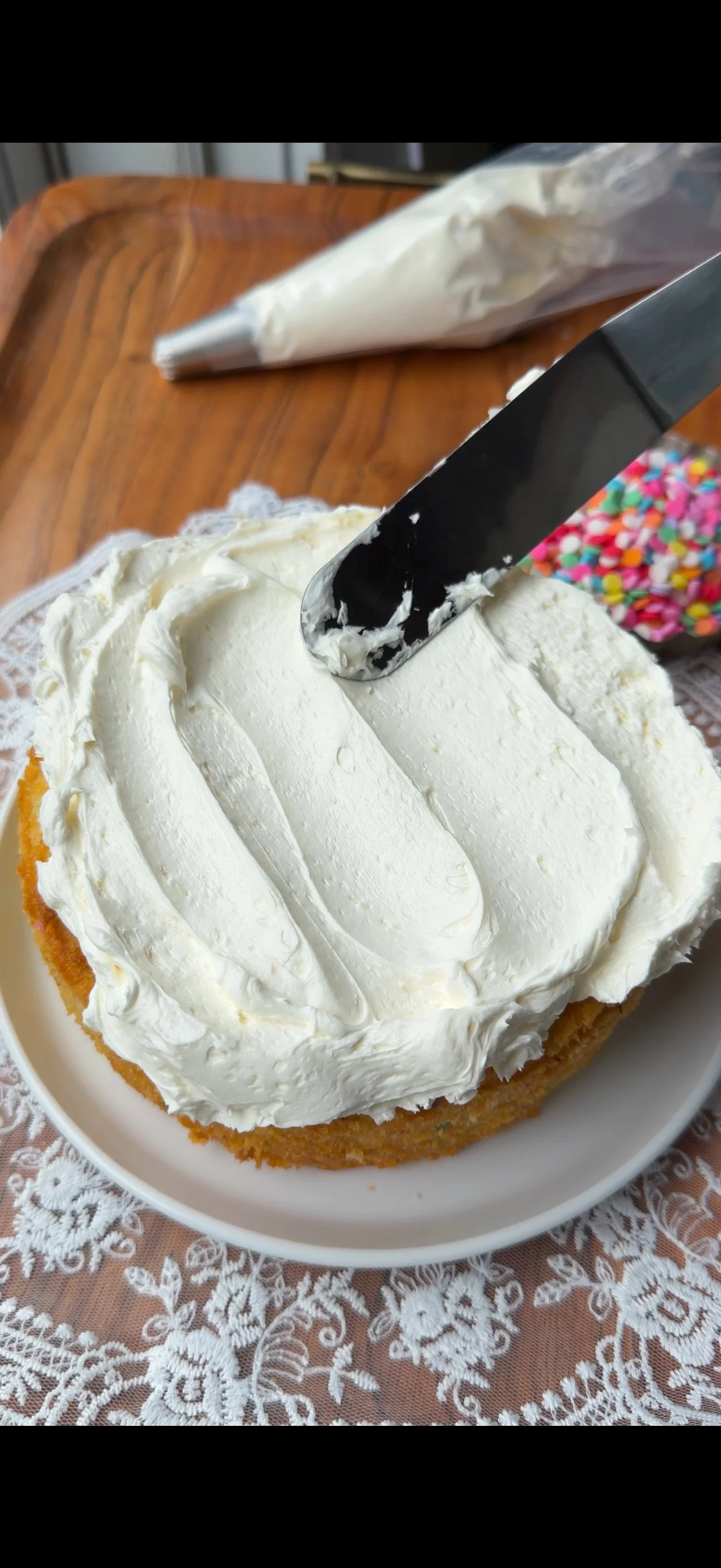 Funfetti cake on the counter with frosting on top
