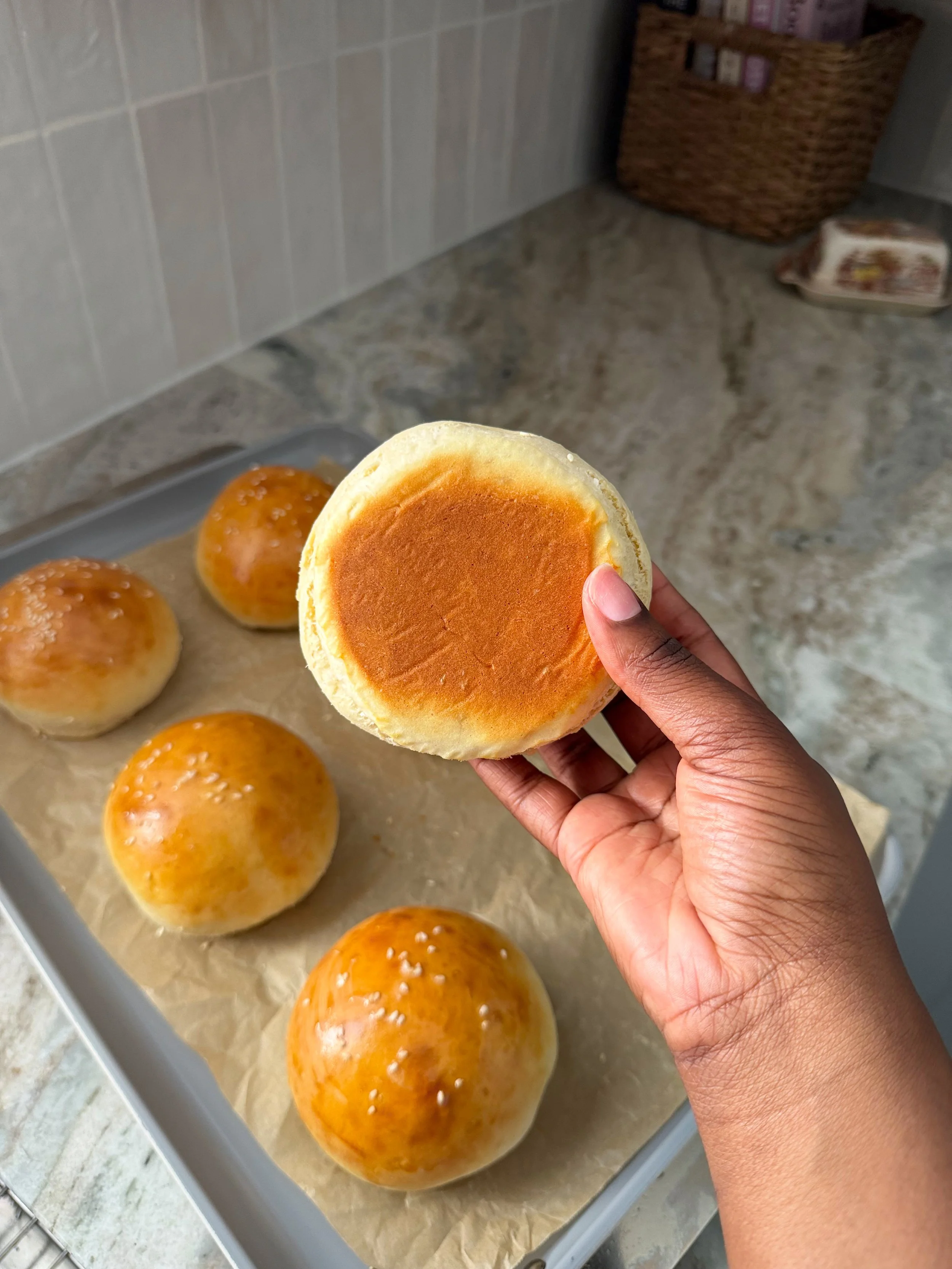 hand holding hamburger bun