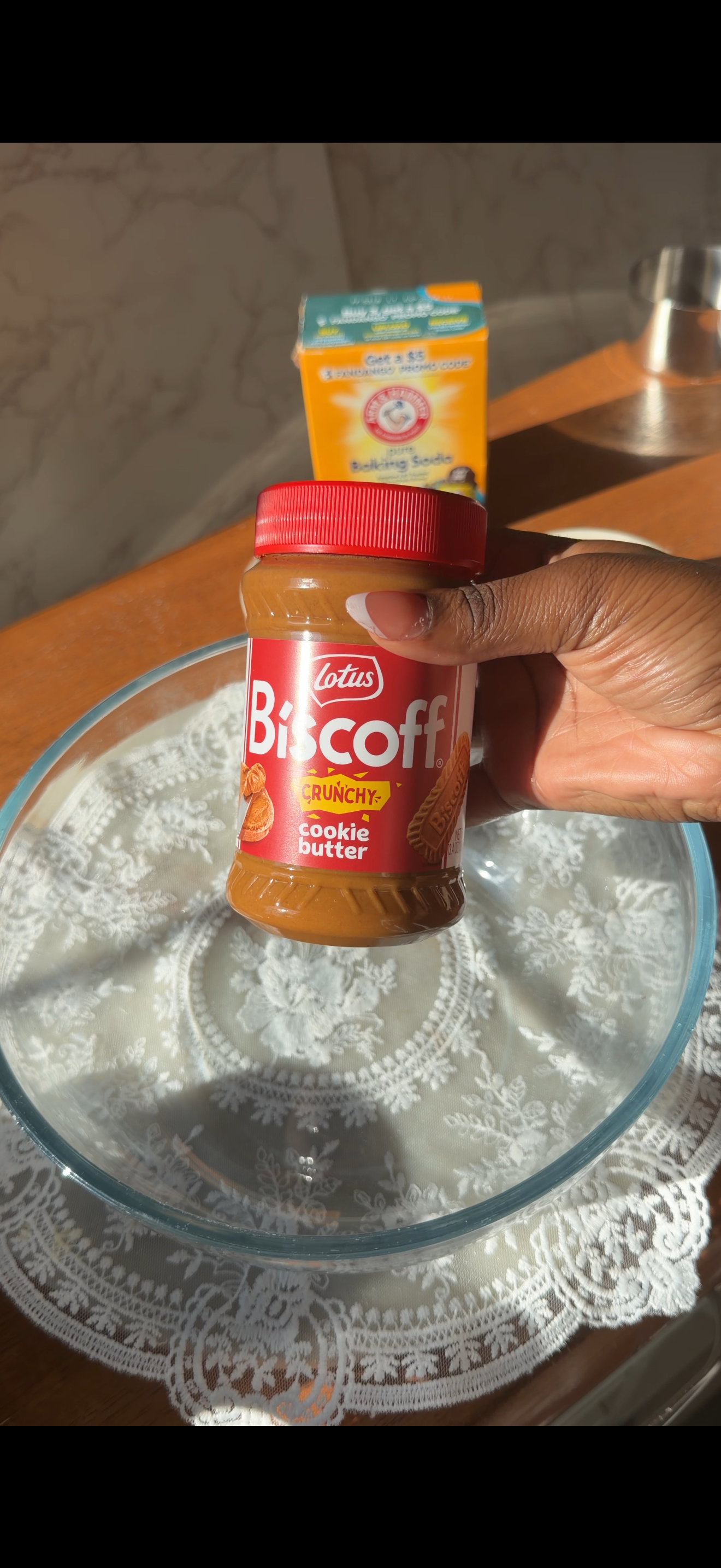 hand holding a jar of biscoff crunchy