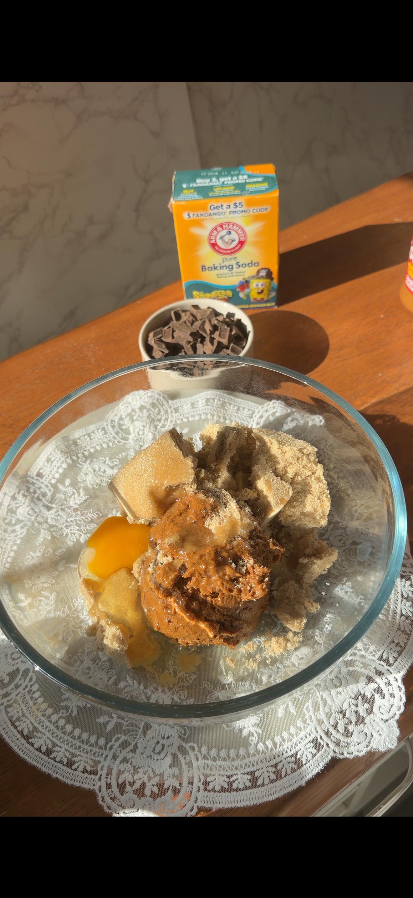 glass mixing bowl with cookie dough on the counter