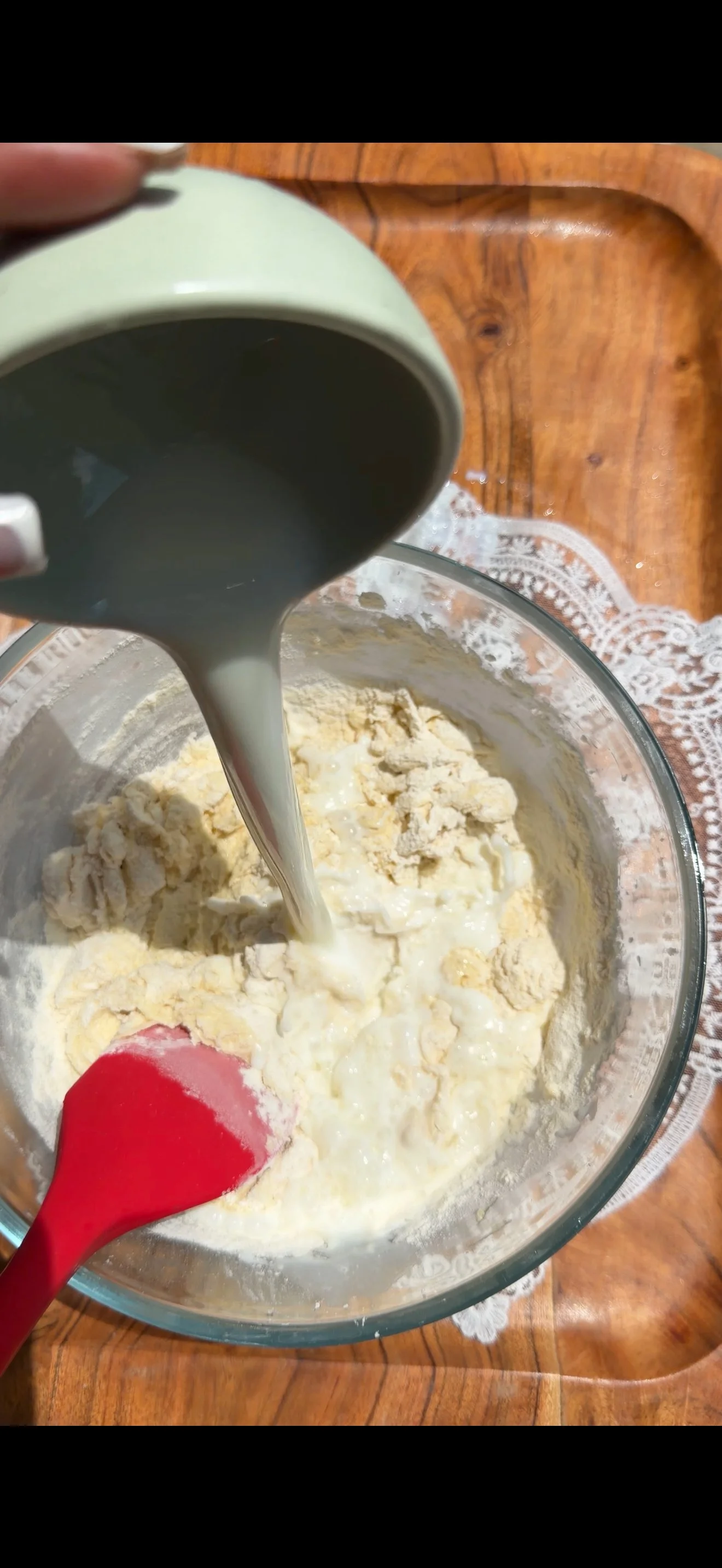 Milk being poured into cake batter. 