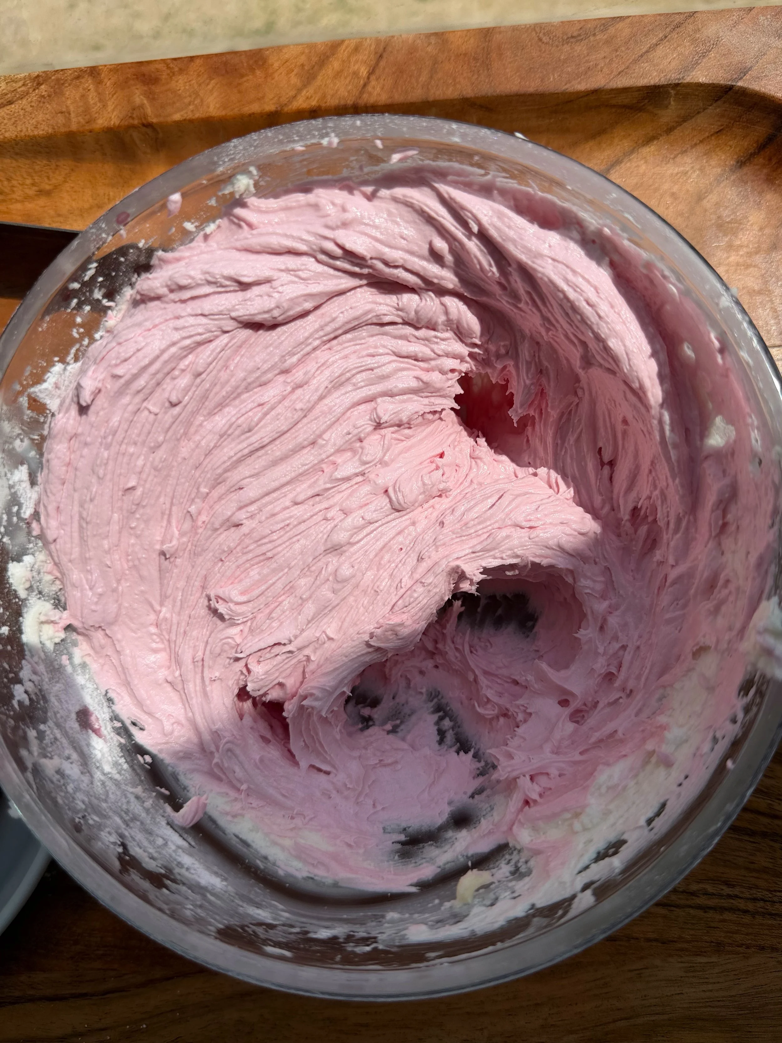 Raspberry buttercream in mixing bowl. 