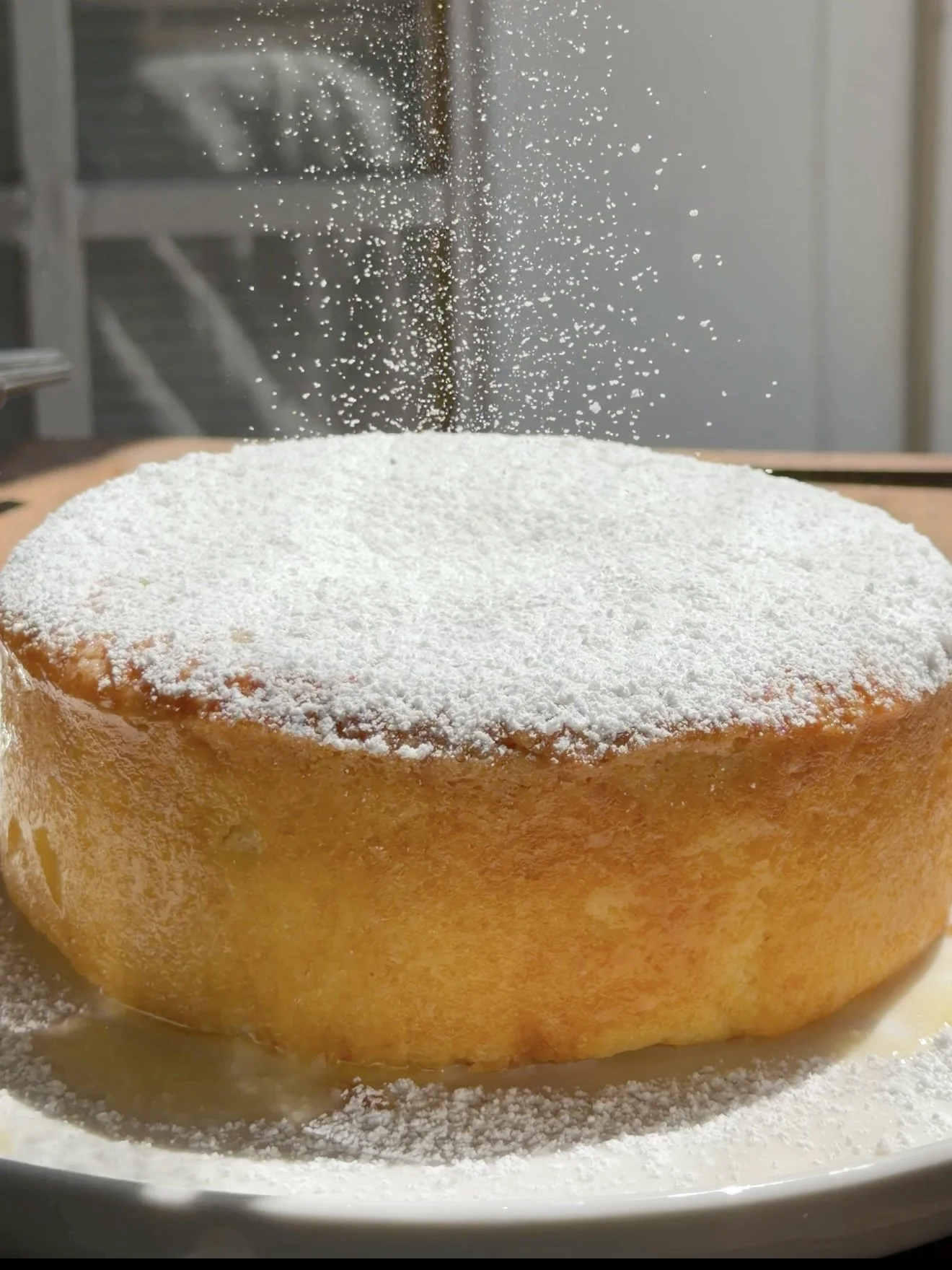 Powdered sugar sprinkled on top of baked cake. 