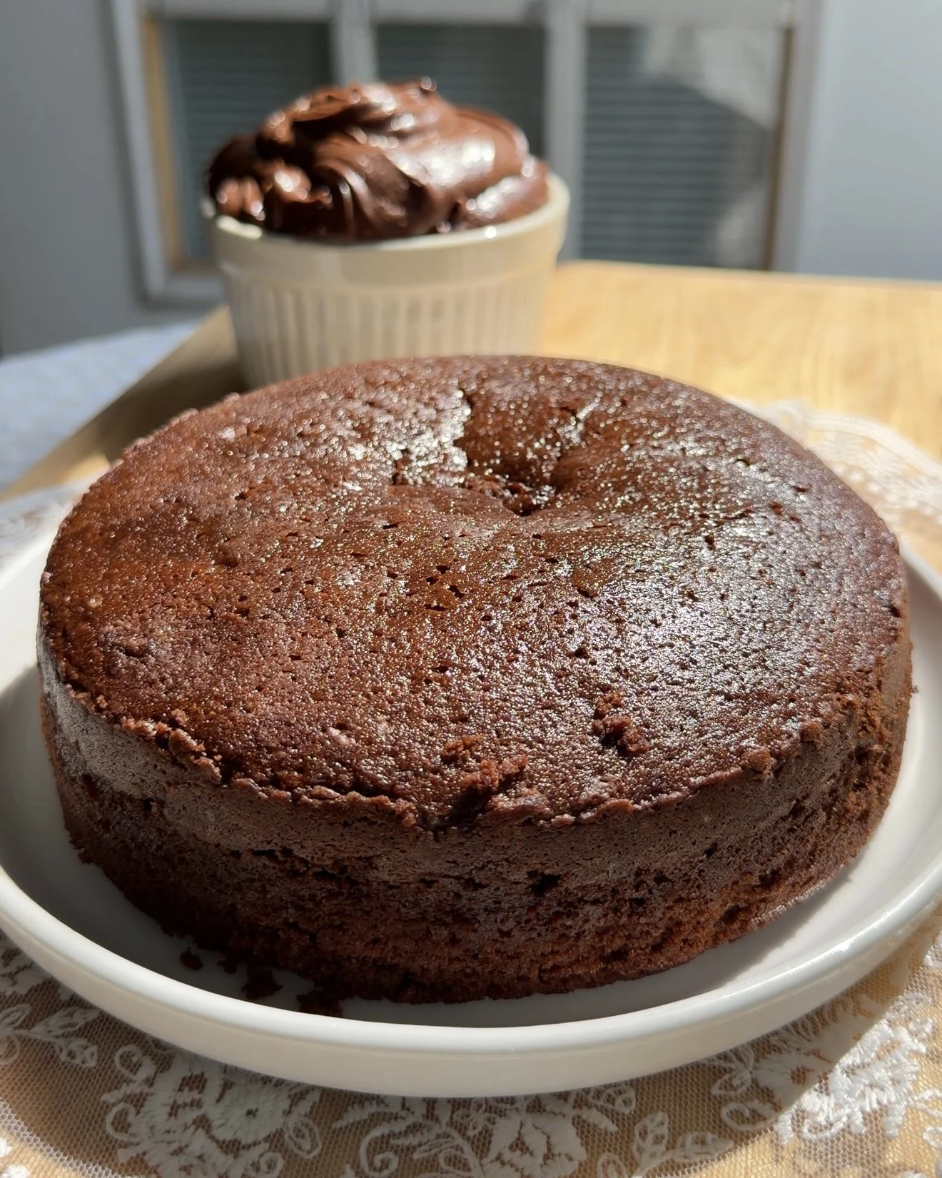 Baked unfrosted chocolate cake on white plate
