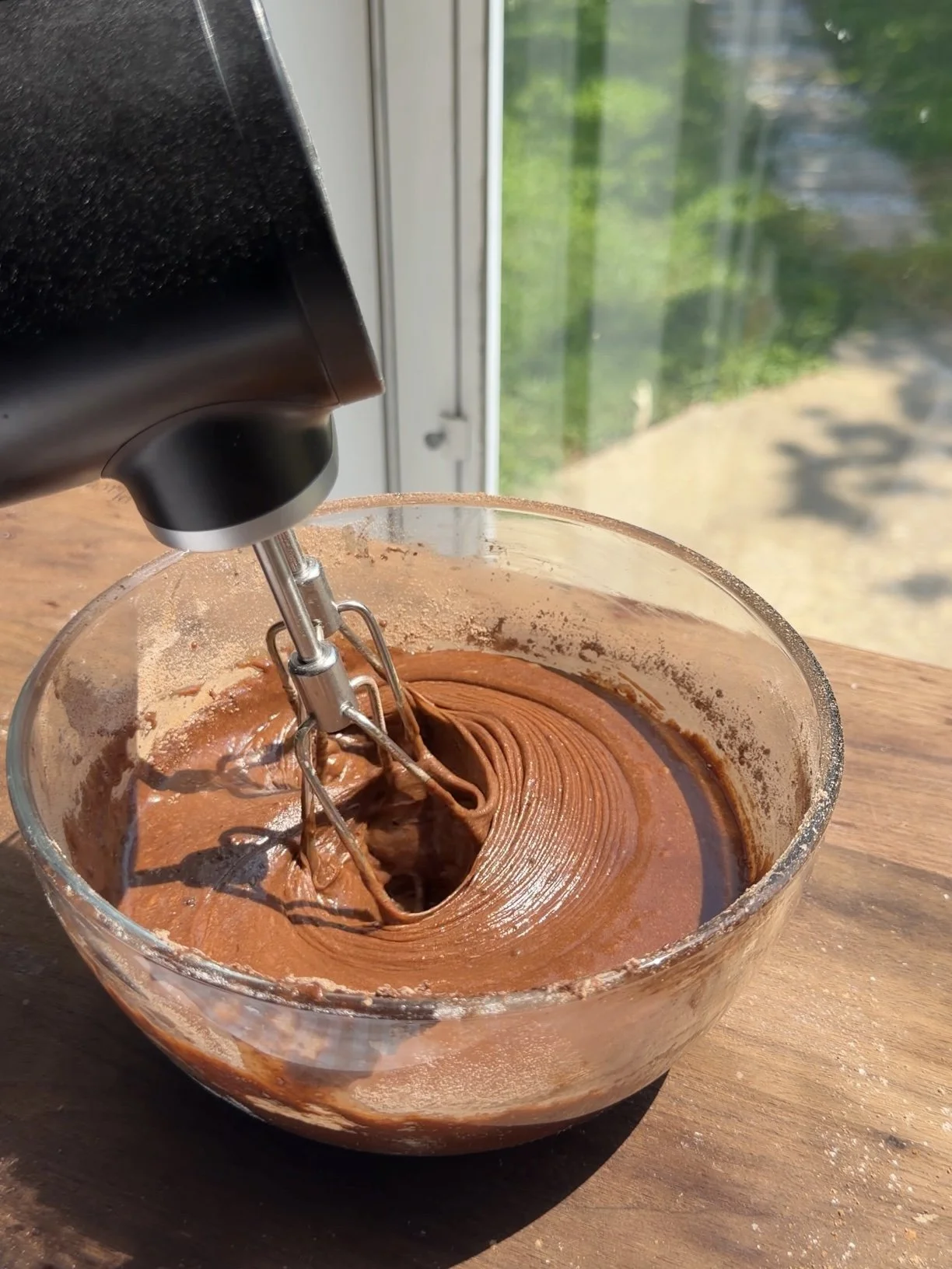 Chocolate cake batter mixed in a bowl before baking