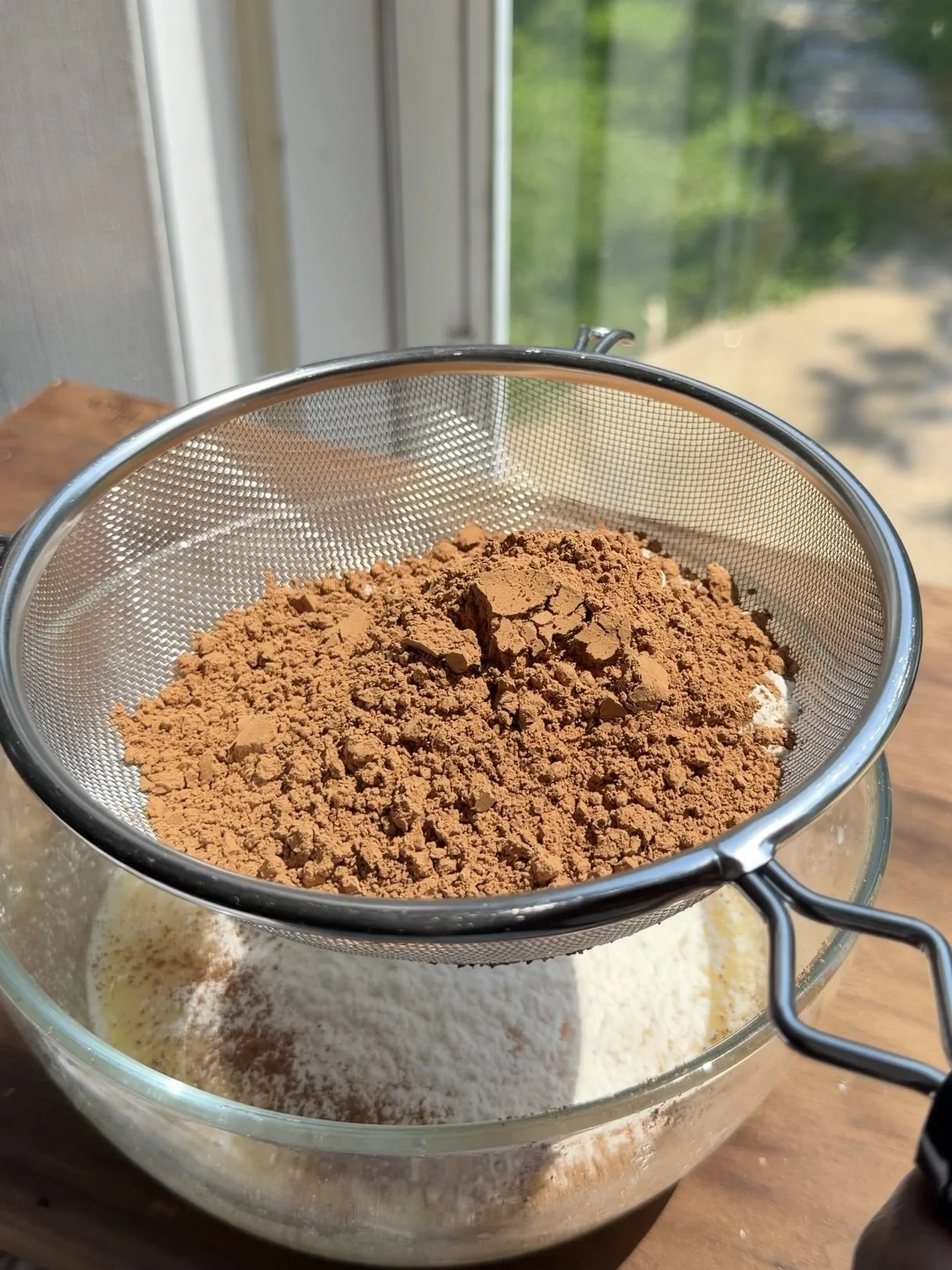 Small bowl of dry ingredients being whisked together for a chocolate cake