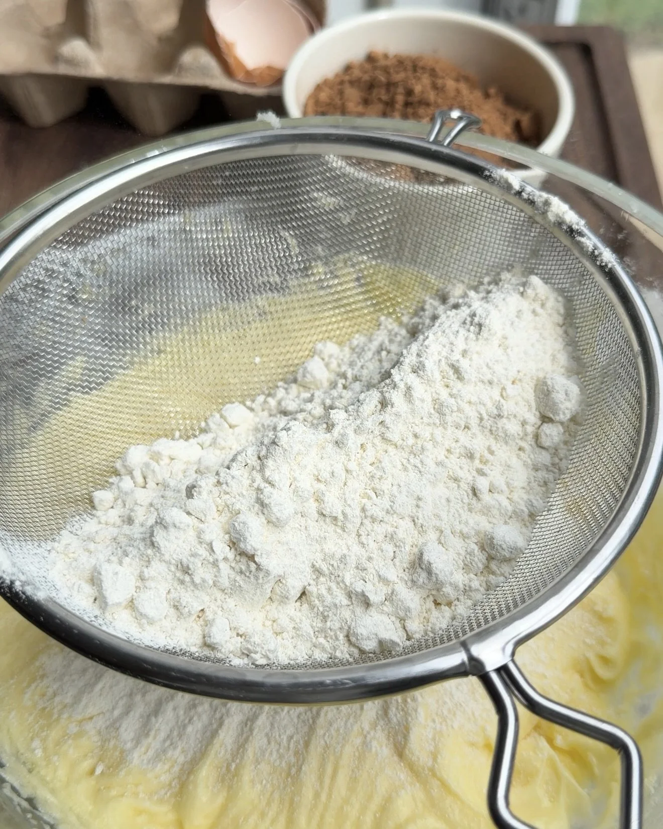 Flour sifted into wet ingredients. 