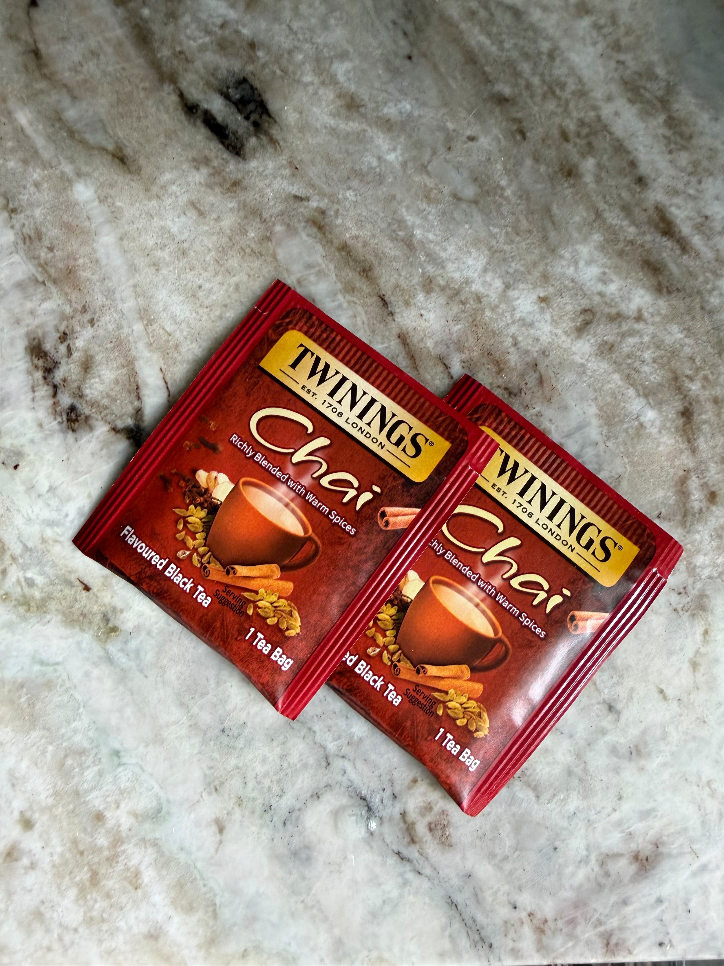 Two red chai tea bags on the counter