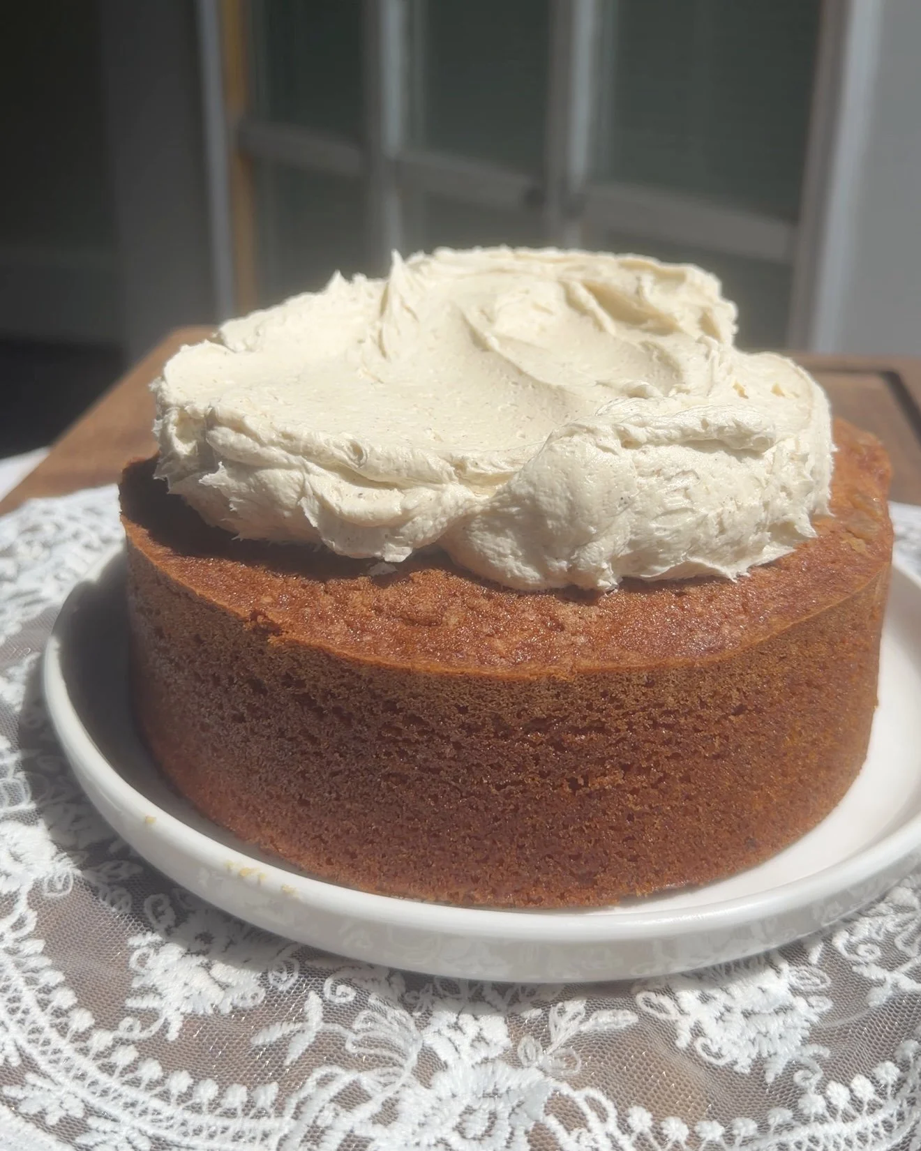 White plate with Mini single layer chai latte cake topped with chai buttercream