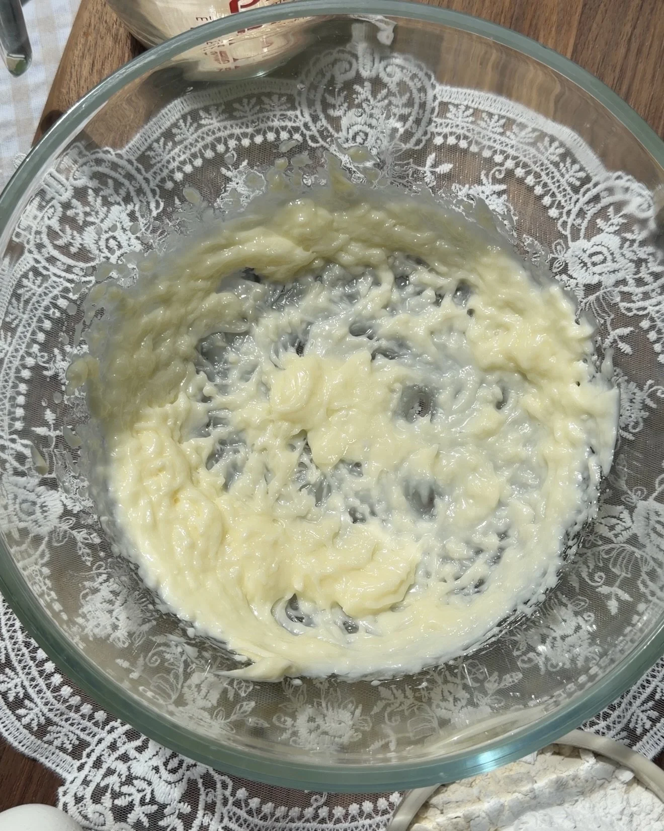 Glass mixing bowl with creamed butter and oil