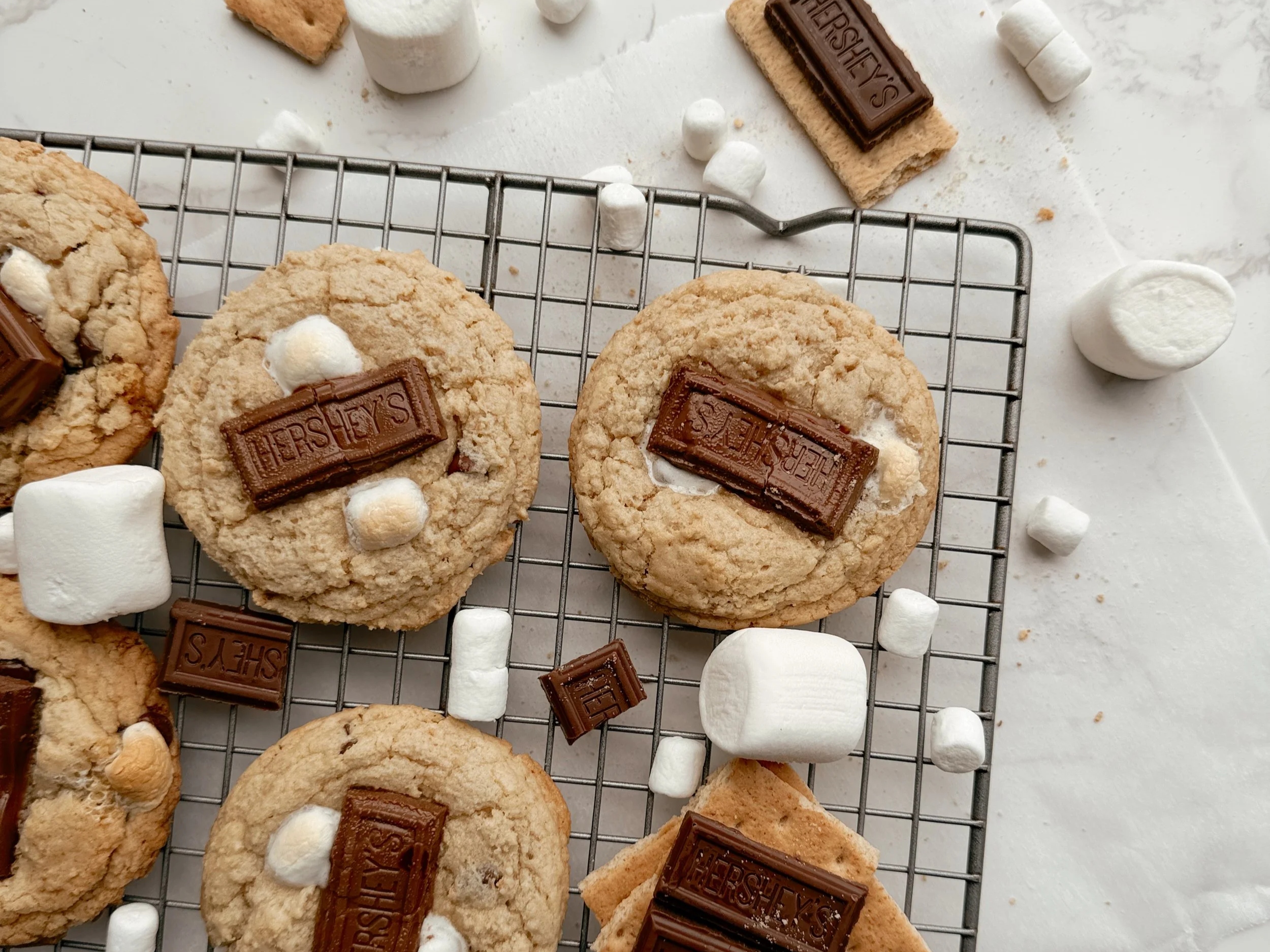 Freshly baked smores cookies cooling on a wire rack