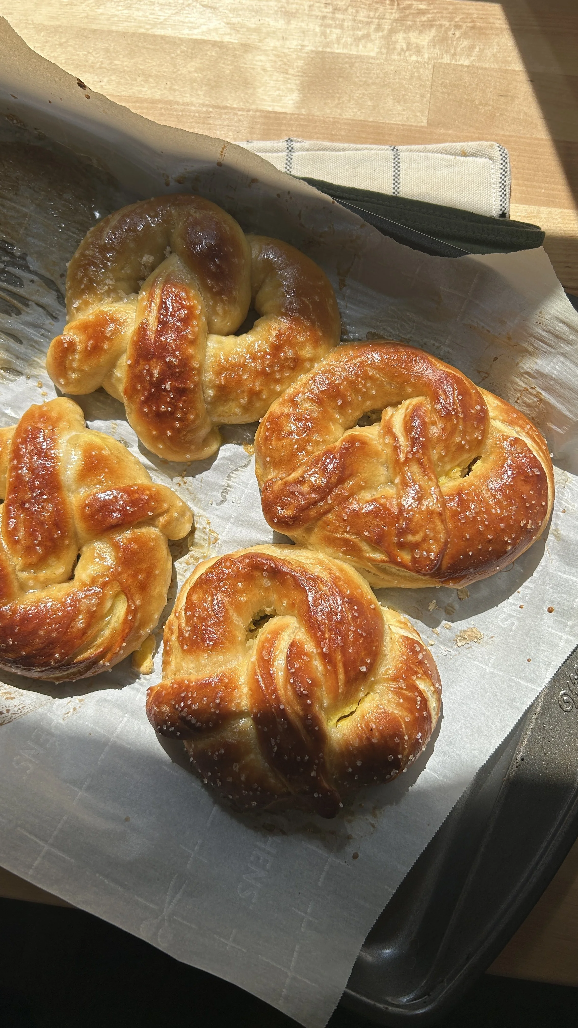 Soft pretzels on parchment paper sheet.