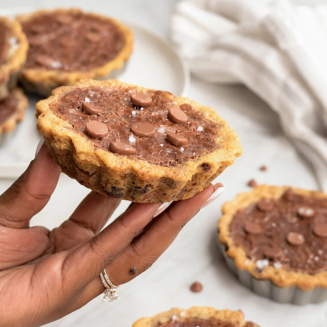 Hand holding brookie tart.