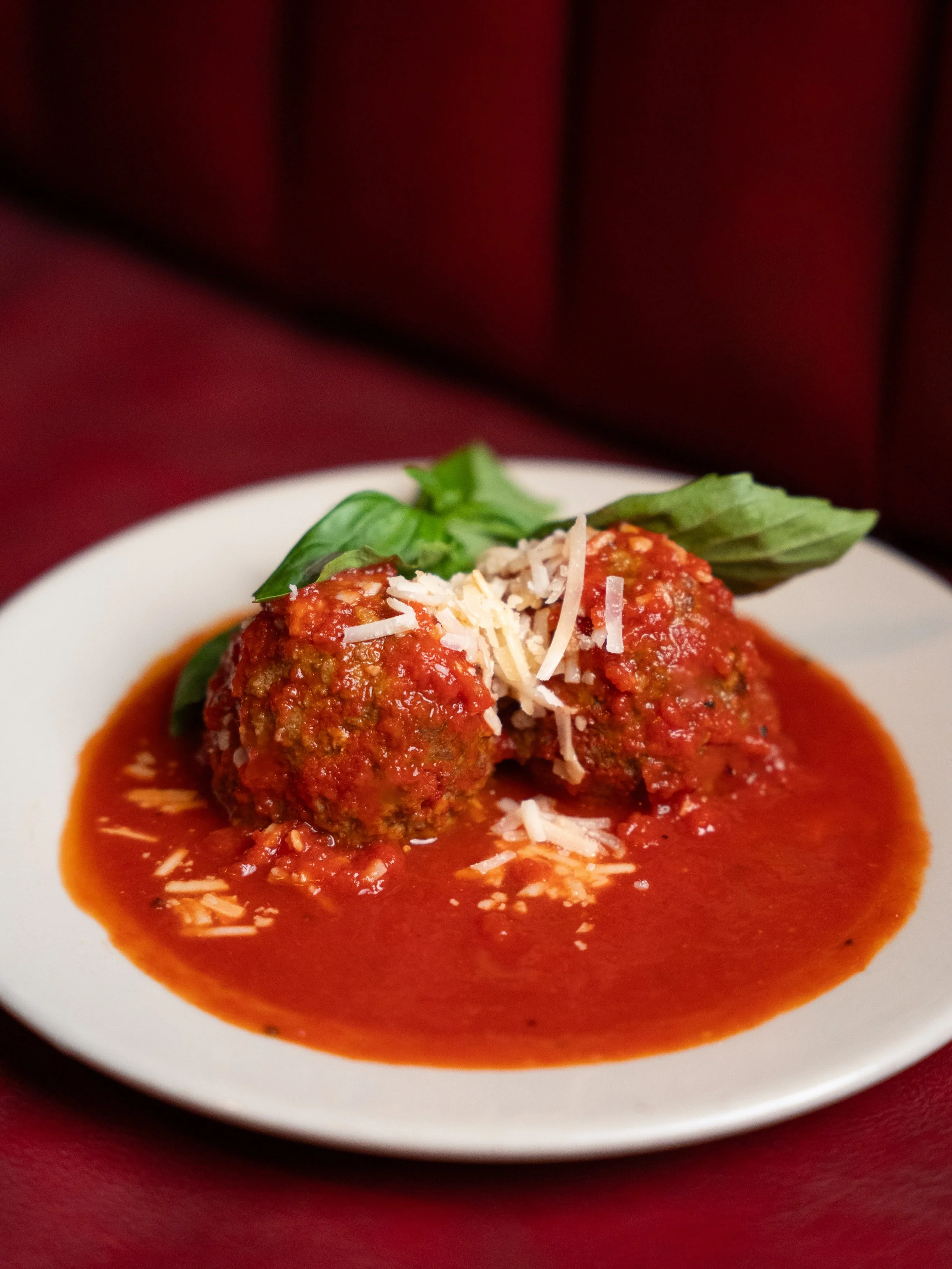 Meet the meatballs.
Homemade daily with 100% Angus beef, drowning in house sauce, and finished with aged Parmesan.