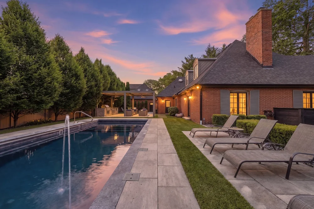 Pool and outdoor living area photographed at twilight