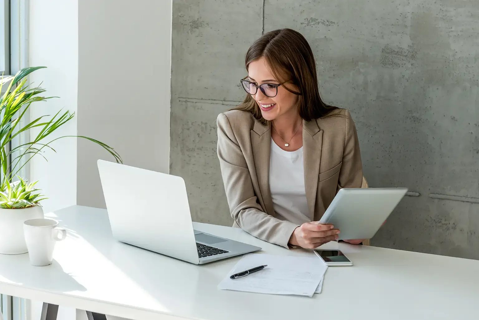 Communications professional at a desk working on stakeholder reports and executive content