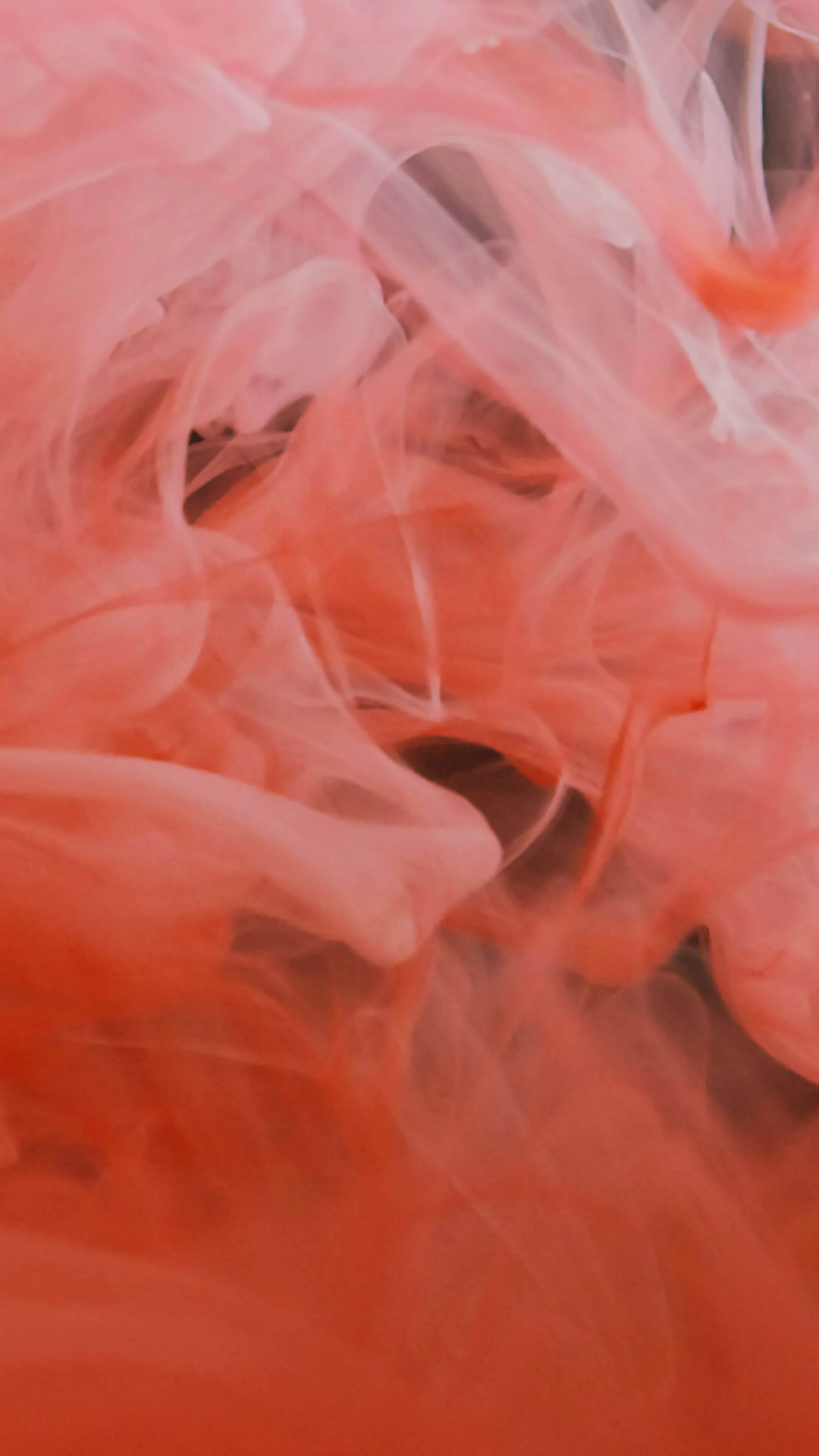 Close-up of pink and white wispy, smoky tissue or fabric with a soft, flowing appearance.