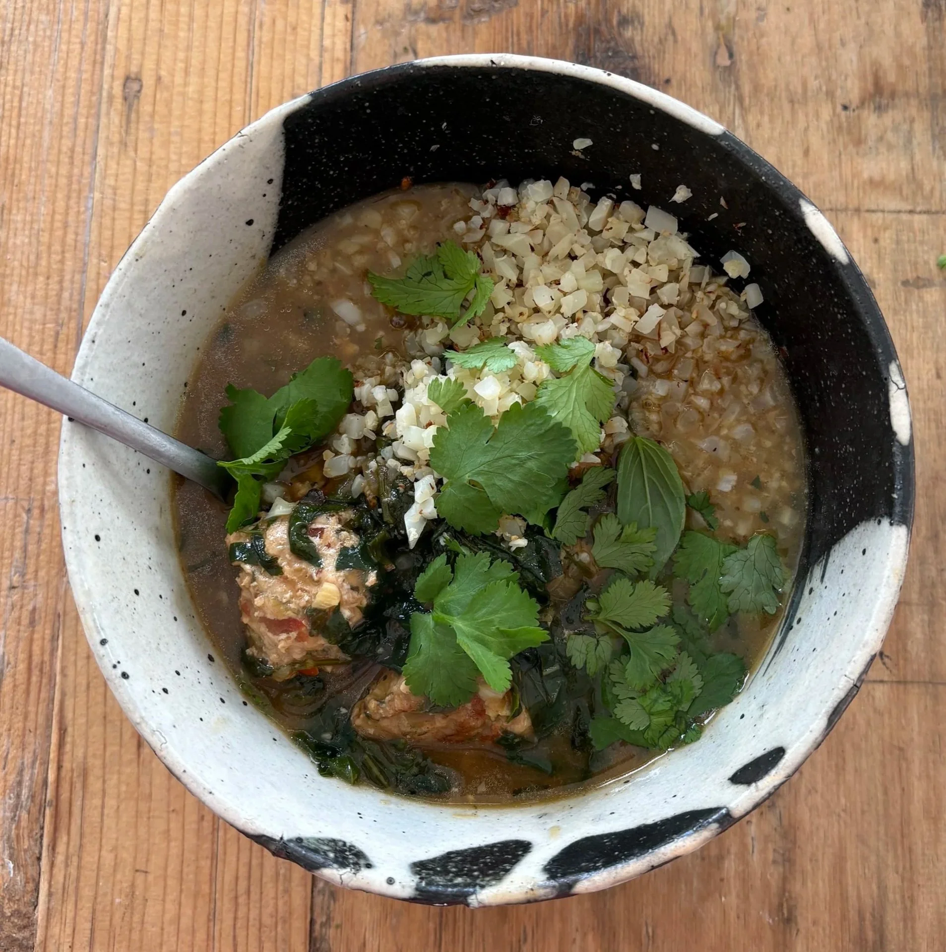 thai chicken meatball curry with cauliflower rice and fresh herbs