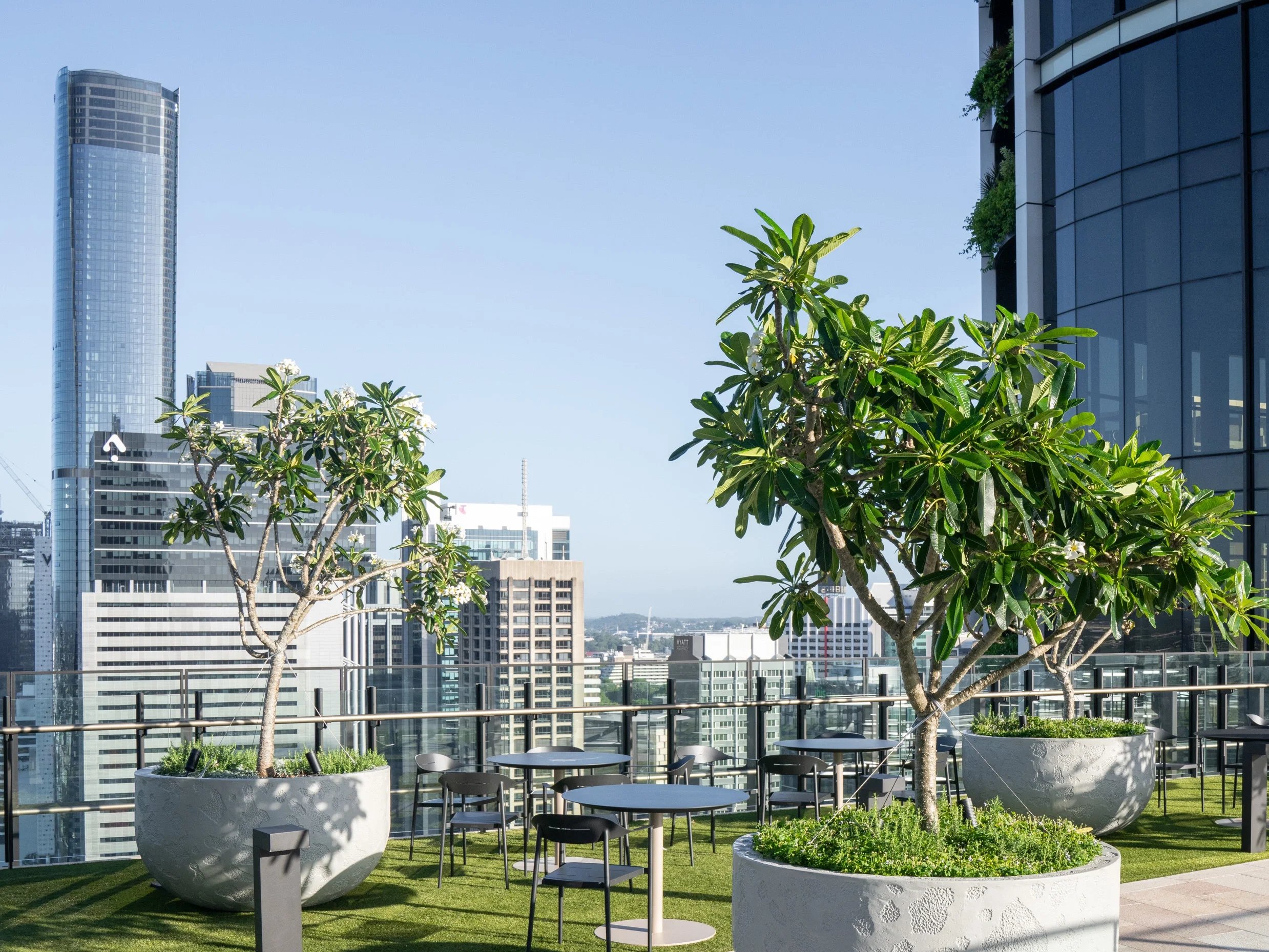 Satu Bumi manufactured large U shaped circular GRC planters with a pitted finish