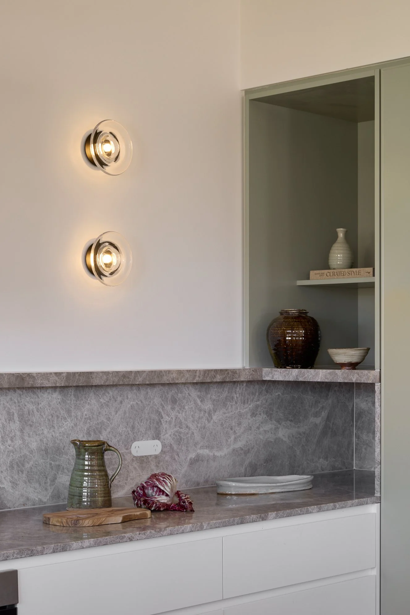 Natural stone kitchen design in Jindabyne featuring Nook Collection Light Sol wall lights by SØKTAS