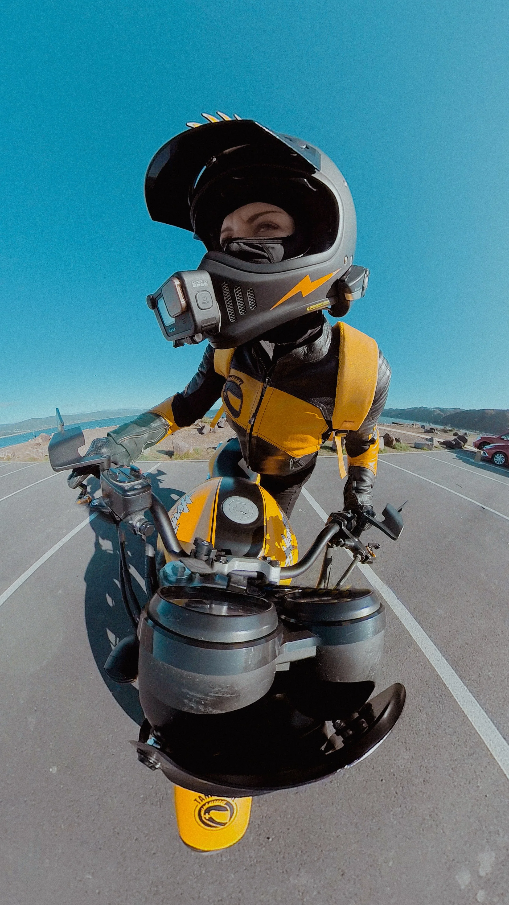 A badass swinging her leg over her motorcycle.