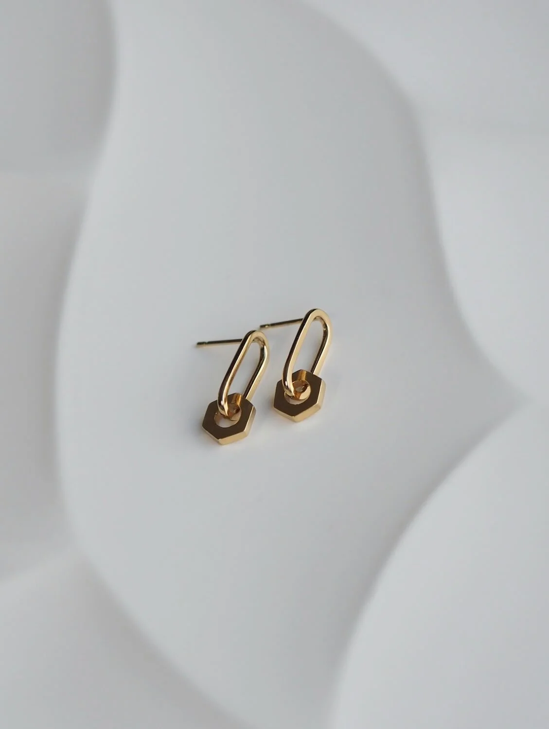 Gold drop earrings with a hexagon drop detail