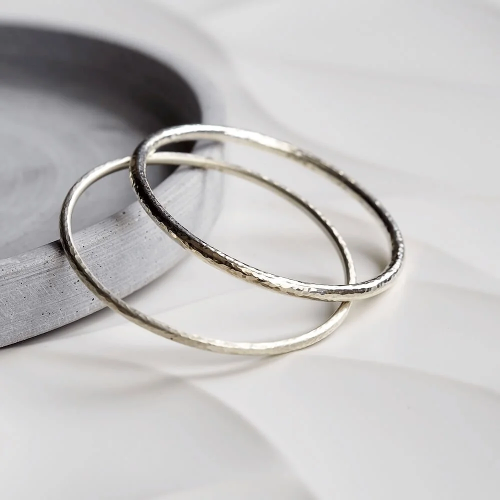 Round hammered Sterling Silver bangle alongside chunky round hammered bangle