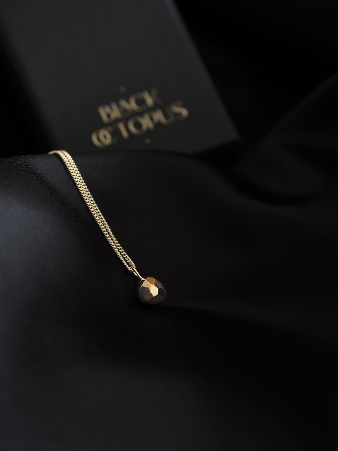 Gold faceted ball geometric pendant on curb chain
