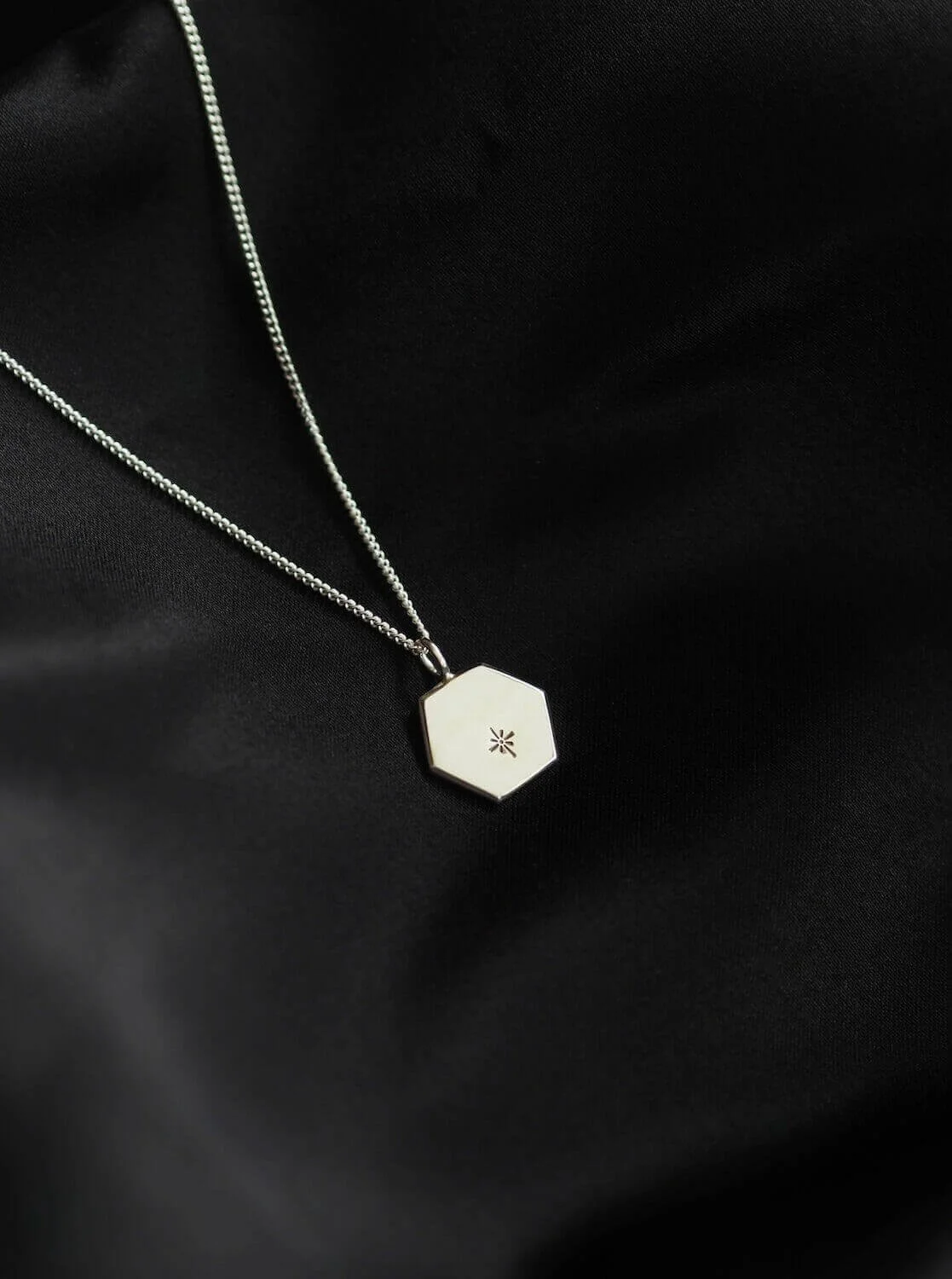Silver hexagon pendant with celestial star design