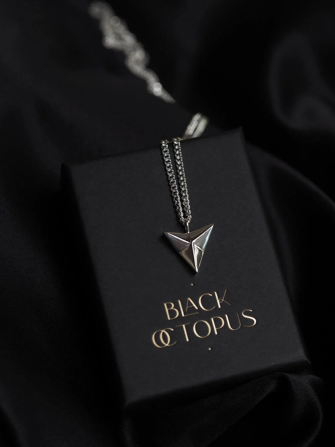 Silver arrowhead pendant necklace on curb chain