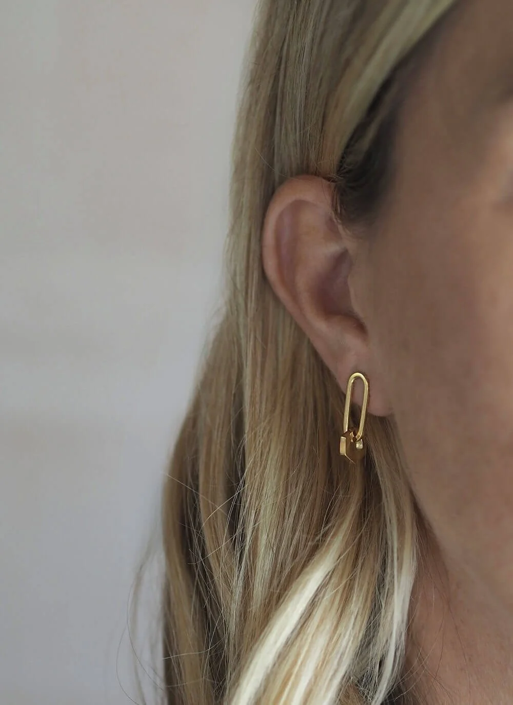 Gold drop earrings with hexagon drop detail modelled
