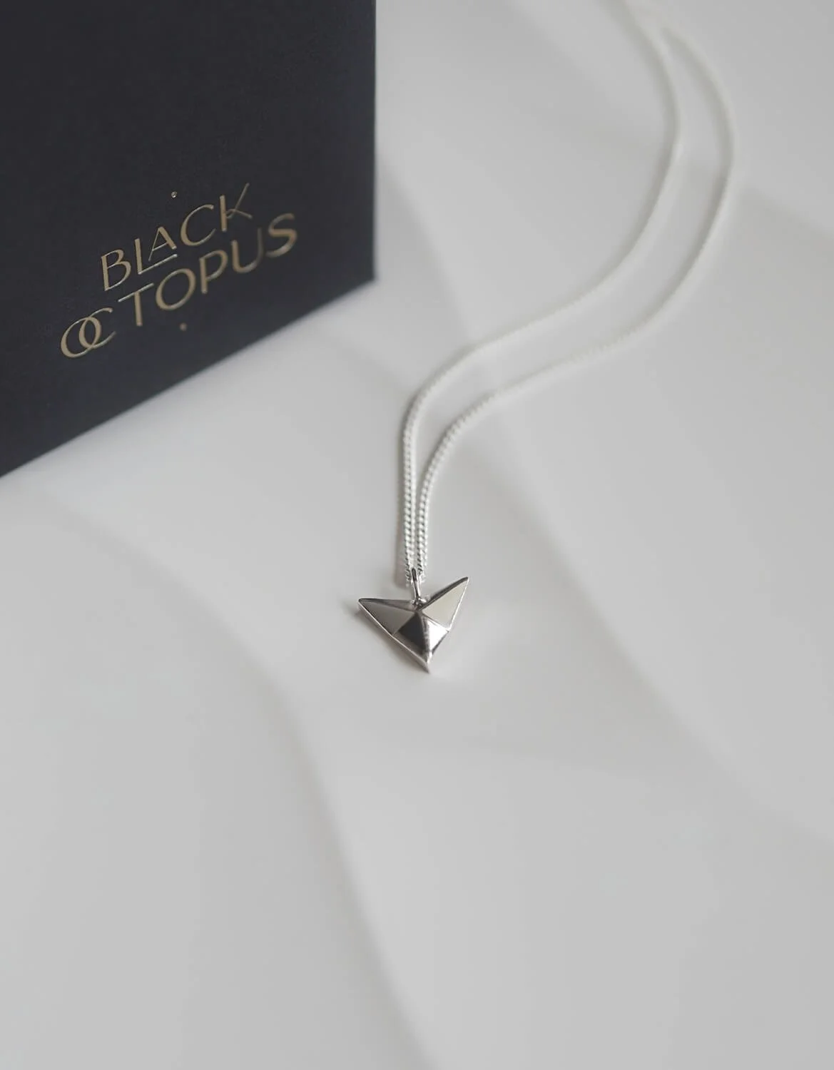Silver arrowhead pendant necklace on curb chain