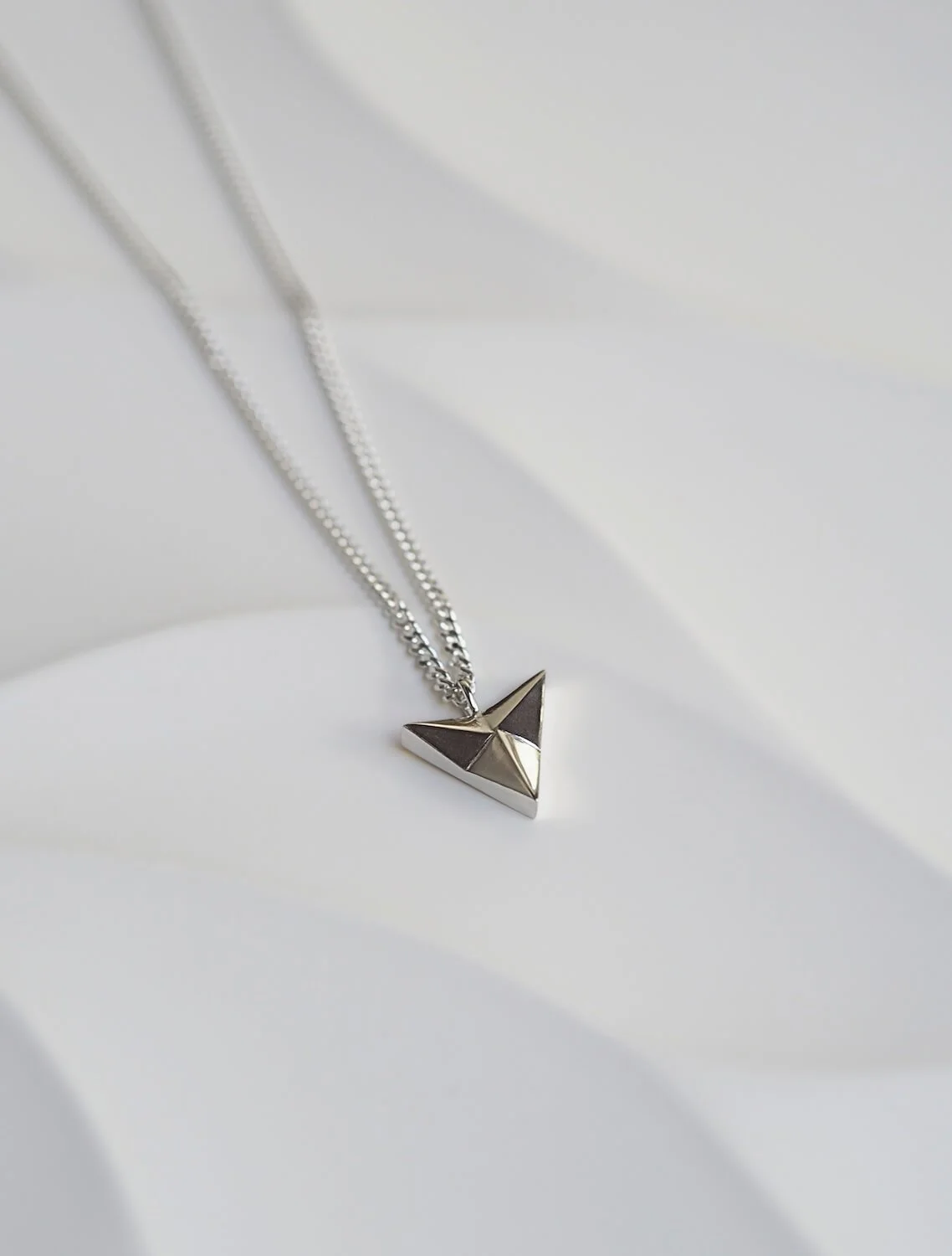 Chunky silver arrowhead pendant necklace on curb chain
