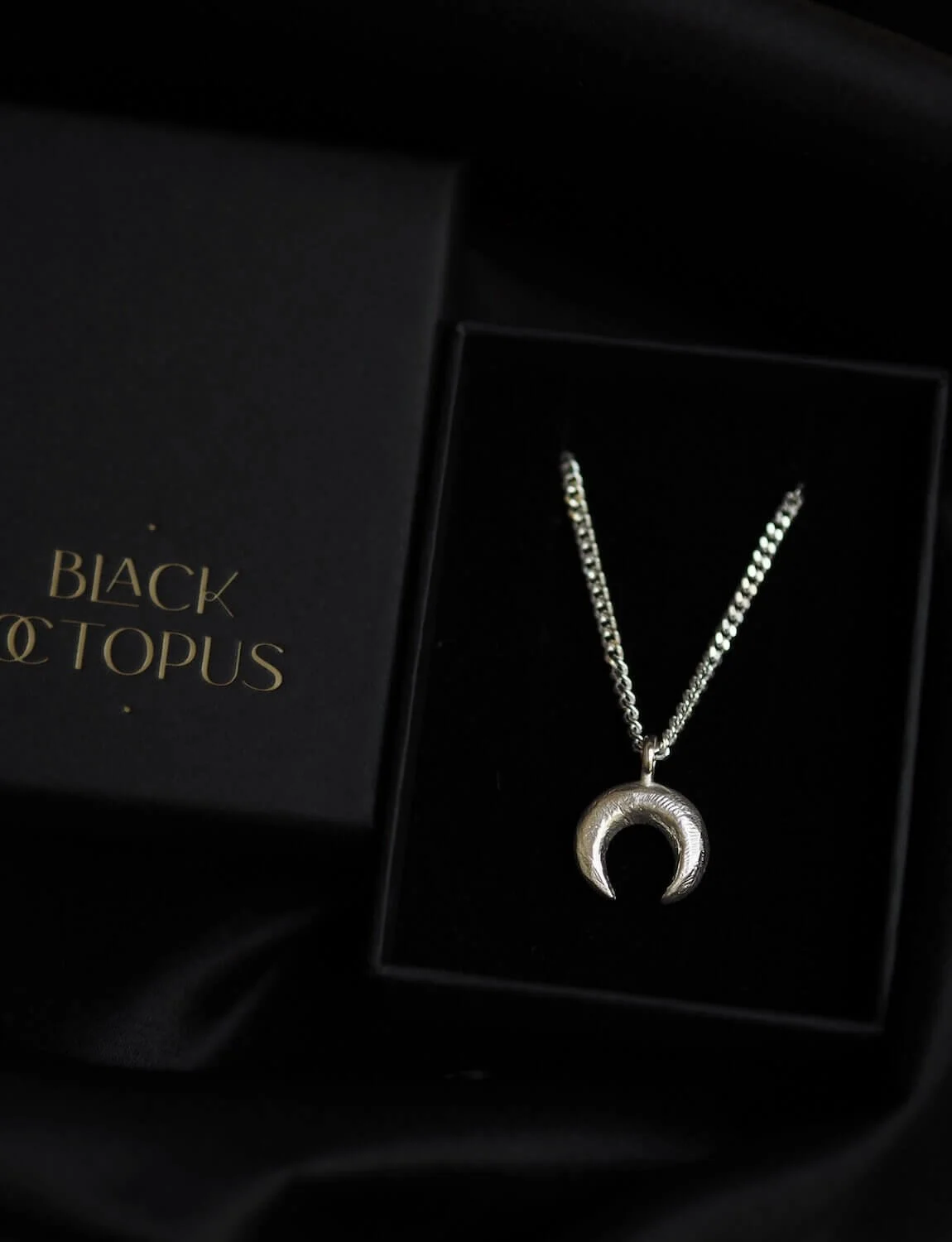 Silver alternative moon crescent pendant with an organic texture