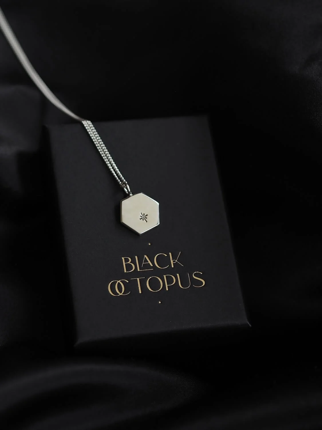 Silver hexagon pendant with celestial star design