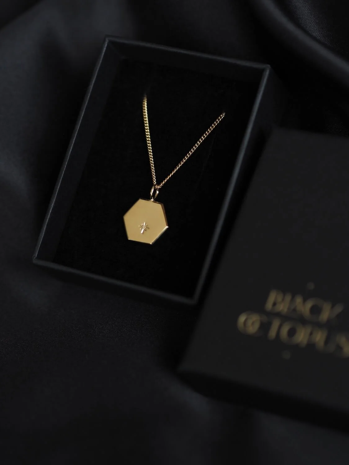 Gold hexagon star pendant on curb chain