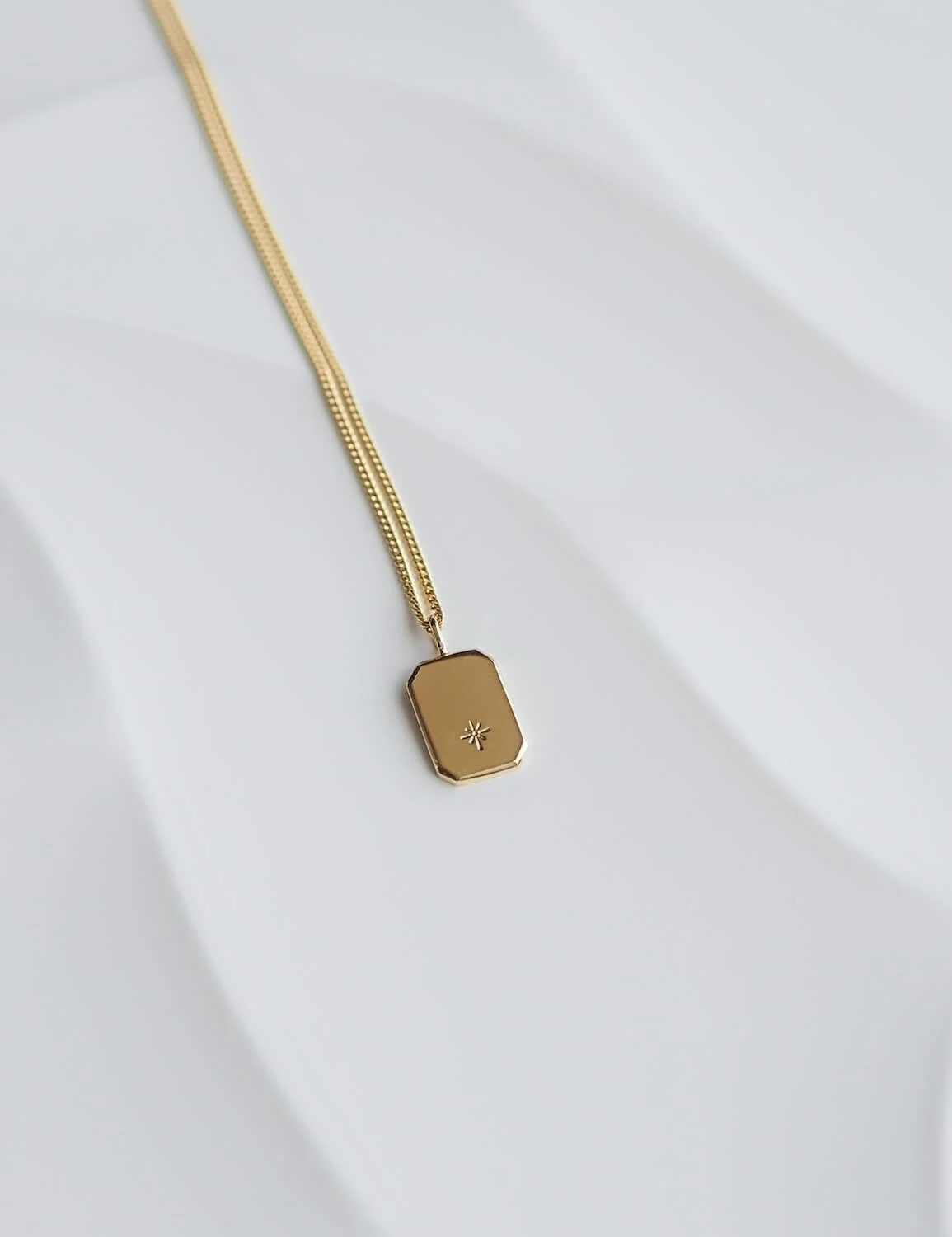 Gold modern rectangle pendant with a celestial star design