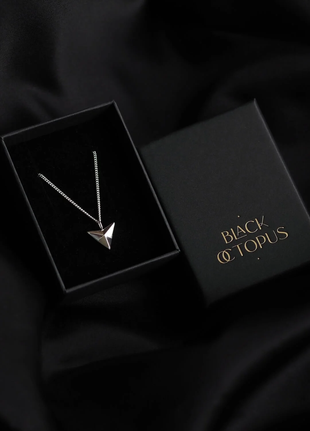 Silver arrowhead pendant necklace on curb chain