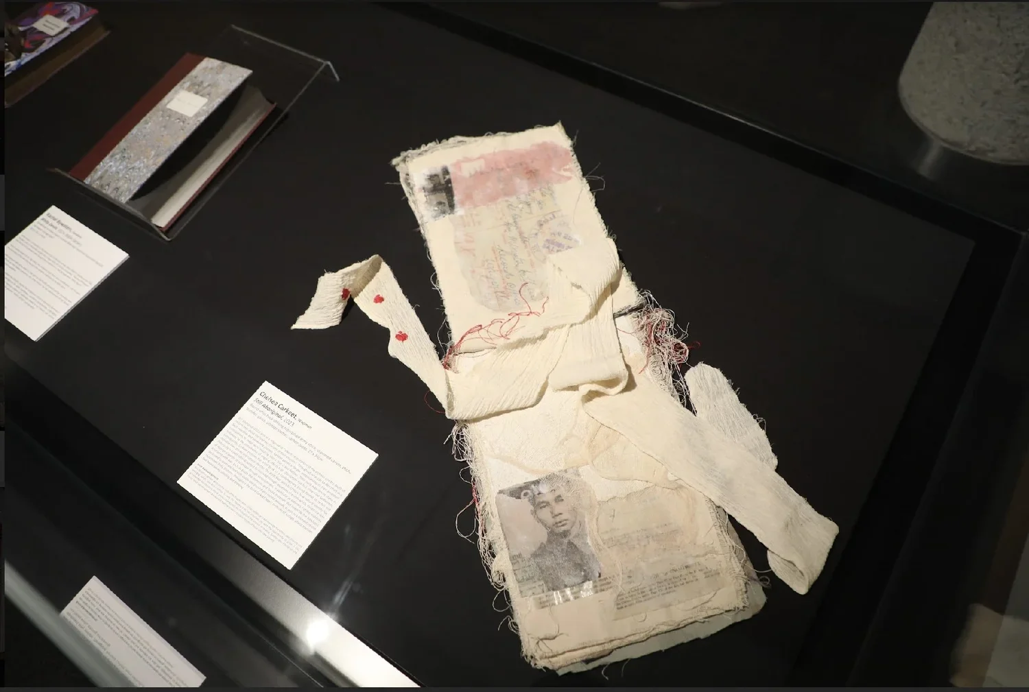 Chelsea Carkeet, Still Aboriginal, 2023, Bound Artist Book utilising repurposed army attire, un-primed canvas, photo transfer, gauze, postage stamps, carbon paper, 23 x 34cm, photo by Christopher Bentley. 