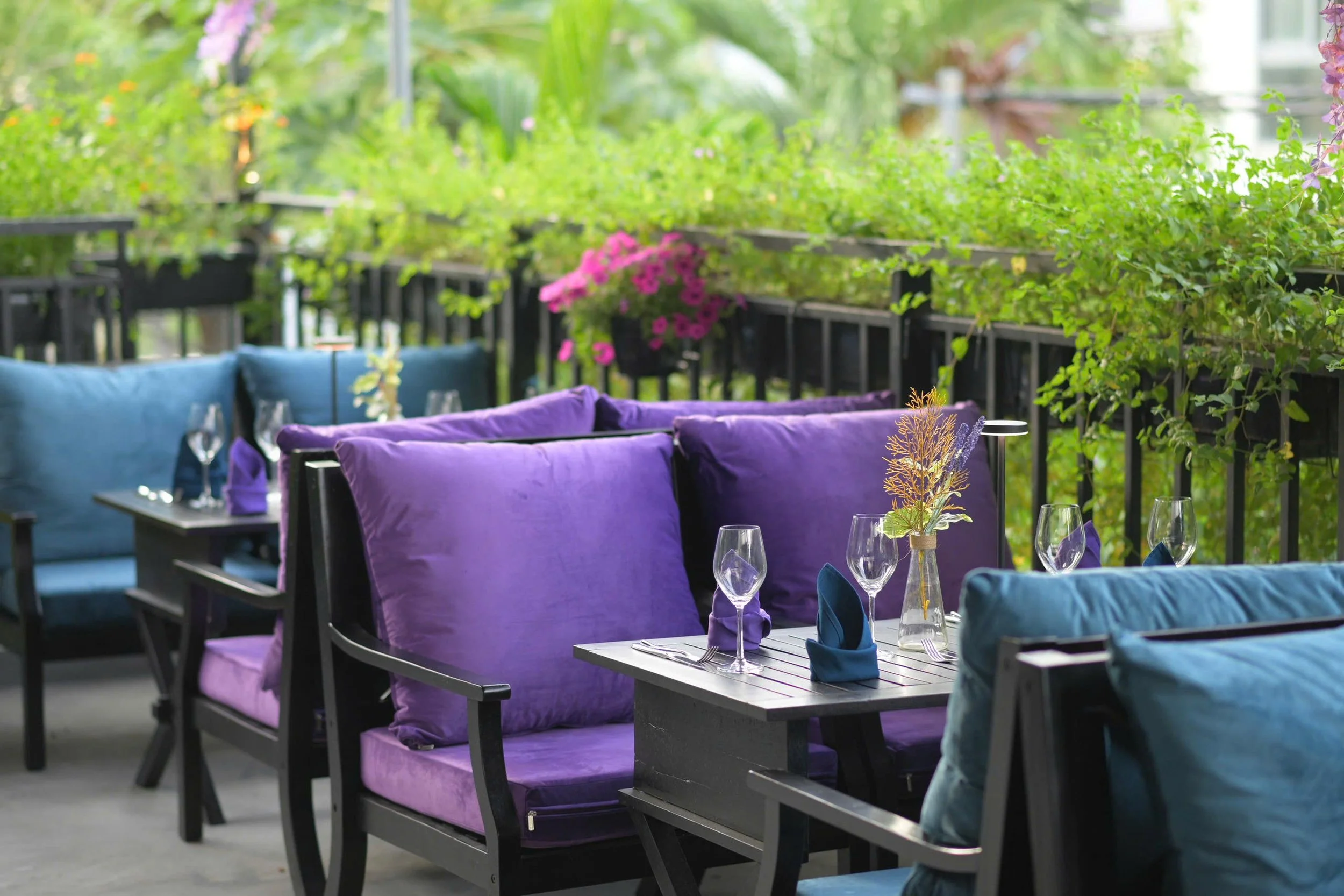 Plush, comfortable and refined setting of the Garden Terrace during the day, nice for a celebratory lunch or dinner at Le Rendez-Vous, gourmet French restaurant in Da Nang, Vietnam