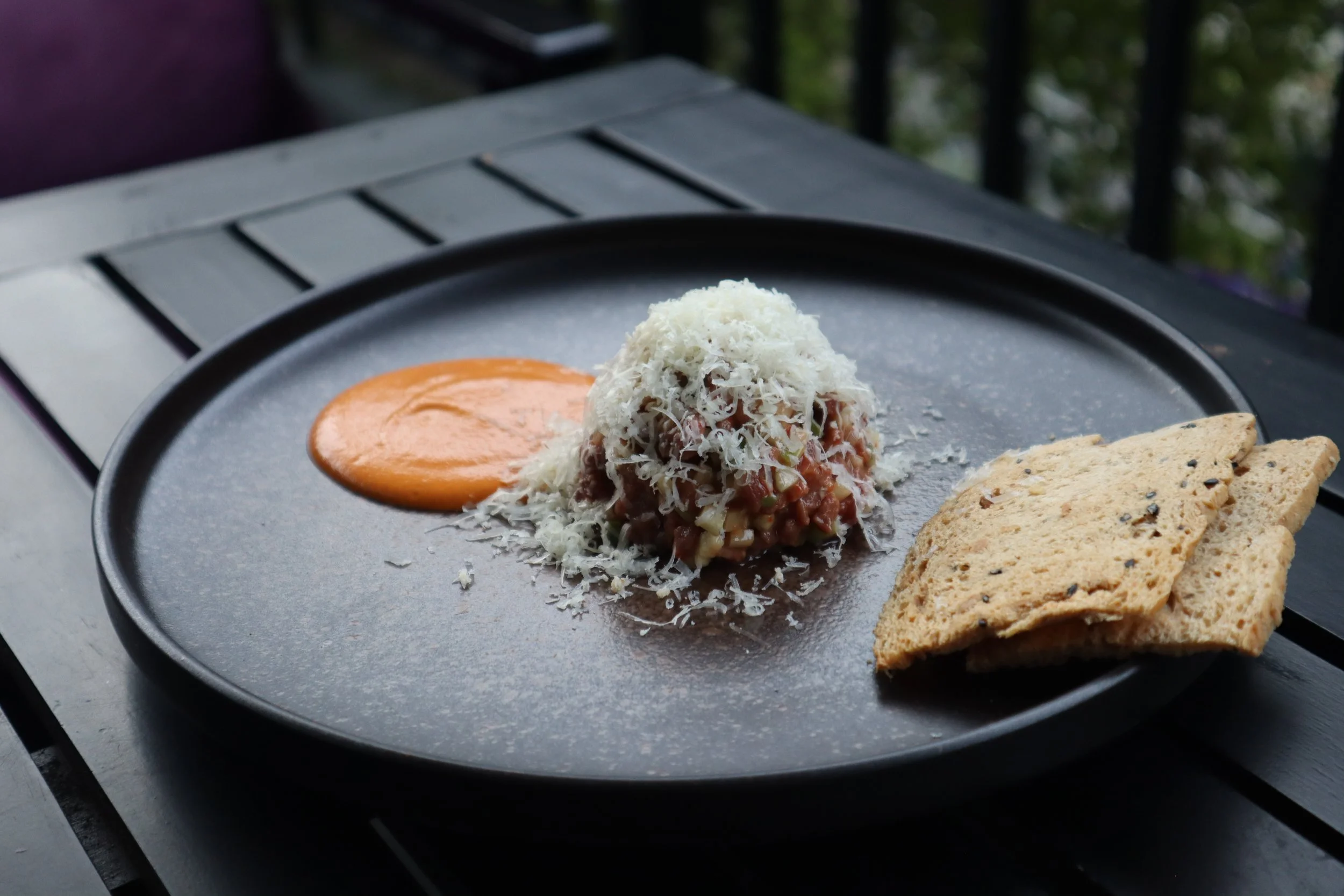Knife-cut tenderloin beef tartare with French Comté cheese, a customer favorite appetizer at Le Rendez-Vous, gourmet French restaurant in Da Nang, Vietnam