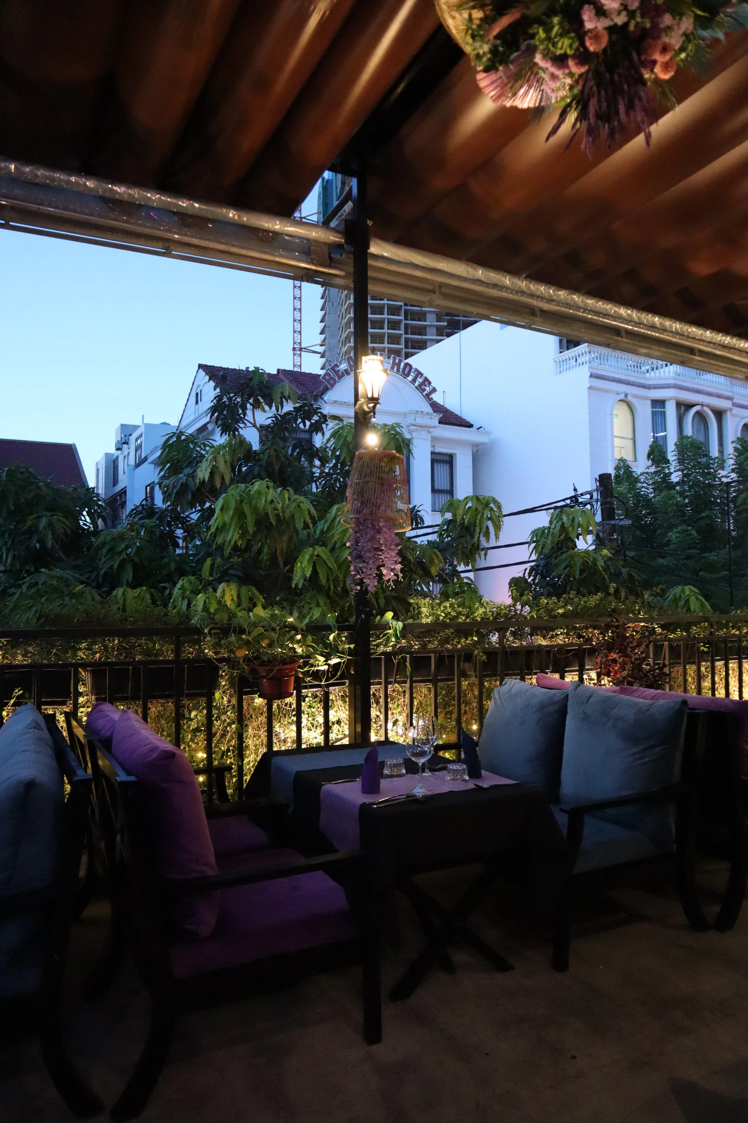 Cosy and romantic setting for a date or dinner with friends or family in the outside terrace at Le Rendez-Vous, gourmet French restaurant in Da Nang, Vietnam
