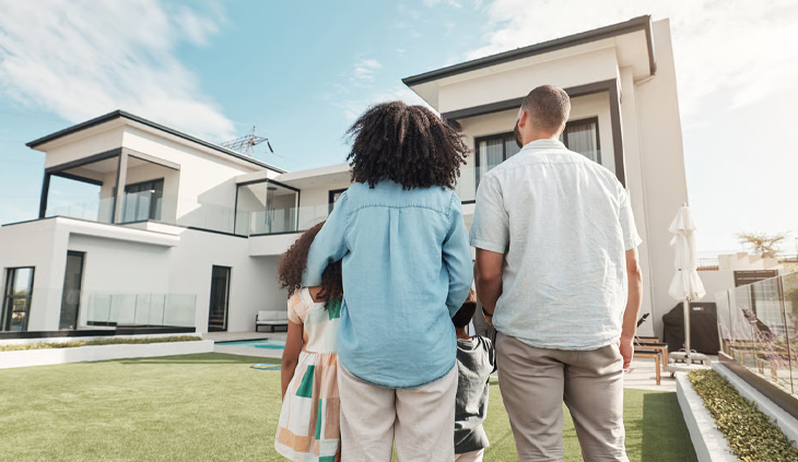 A family looking at a modern luxury house with real estate design.