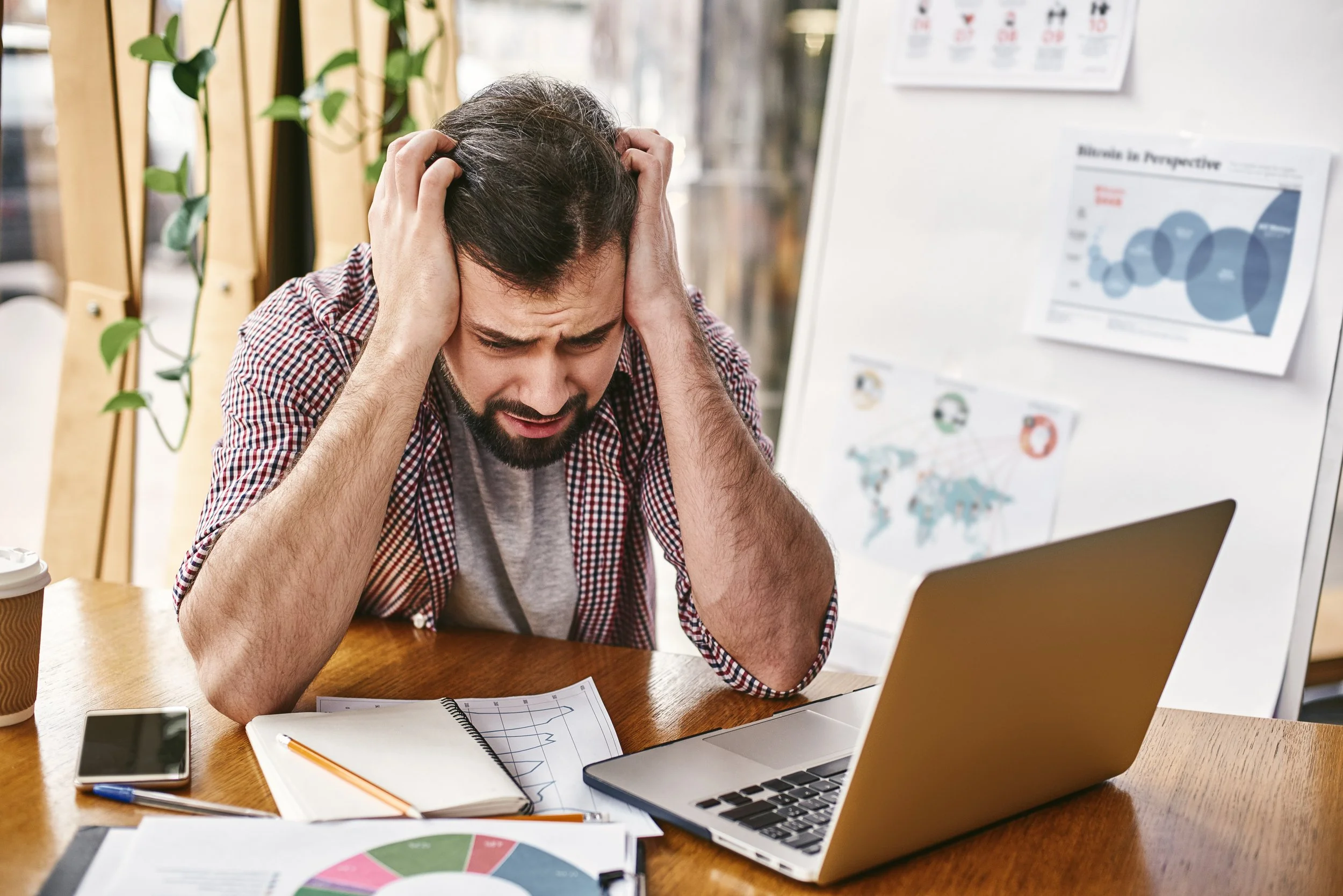 An image of a genuinely frustrated employee at their computer connects the abstract idea of "poor governance" to the very real human cost of lost productivity.