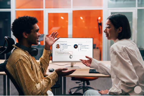 Co-worker chatting each other in office with the Steegle AI People at desktop