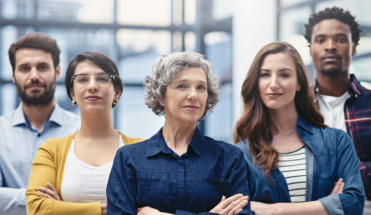 A confident, diverse enterprise team standing together in the office.