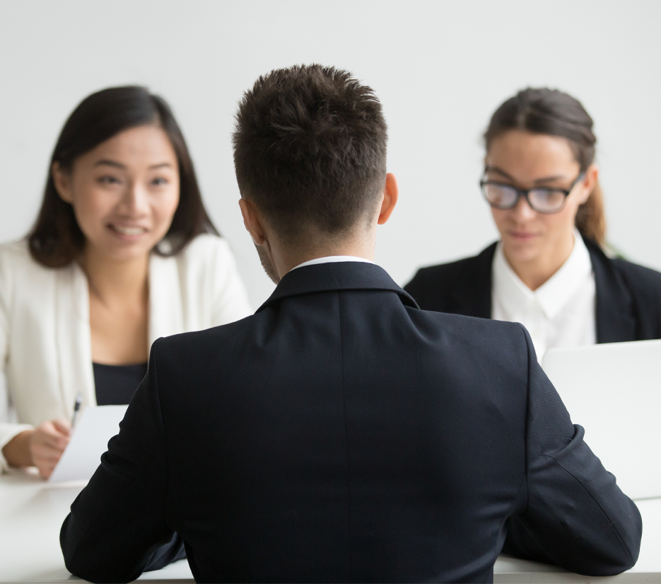 HR manager assisting two new employees during the onboarding process