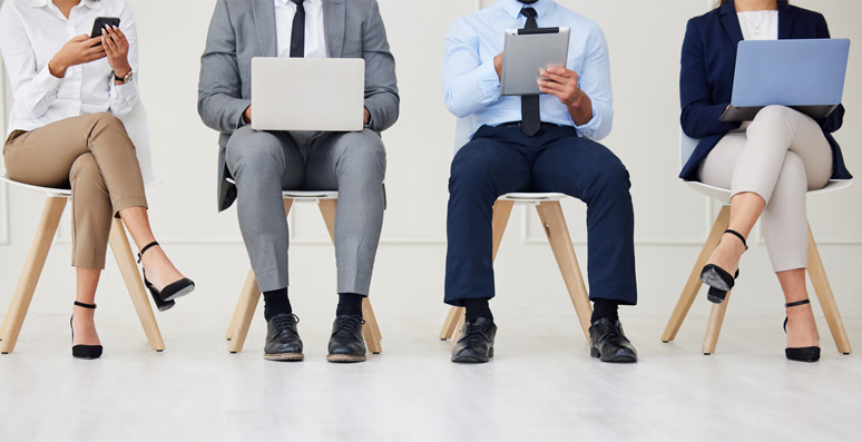 Business professionals seated in line.
