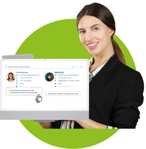 A professional woman holding a computer screen displaying an AI-powered employee directory search for "Japanese business experience," showing profile results for Carol Danvers and Kaori Nishinosono.
